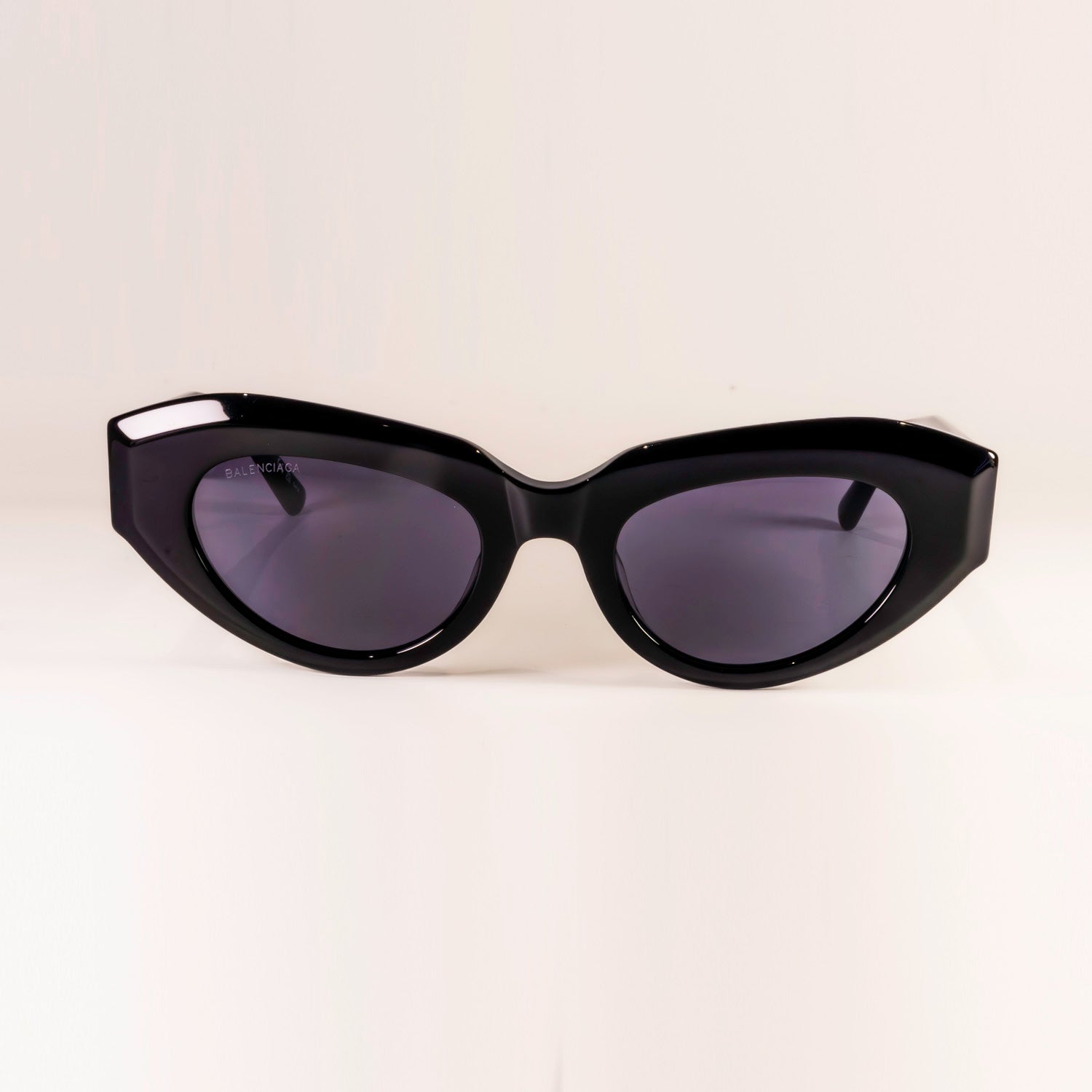 BALENCIAGA SUNGLASSES BB0236S featuring cat-eye shape and grey lenses, set against a stylish background.