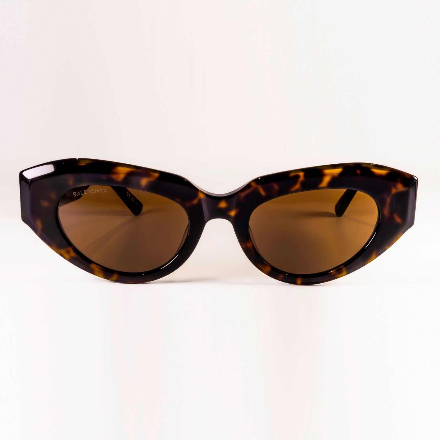 BALENCIAGA SUNGLASSES BB0236S featuring cat-eye shape and grey lenses, set against a stylish background.