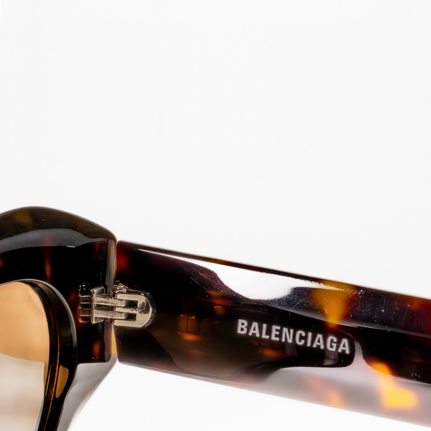 BALENCIAGA SUNGLASSES BB0236S featuring cat-eye shape and grey lenses, set against a stylish background.