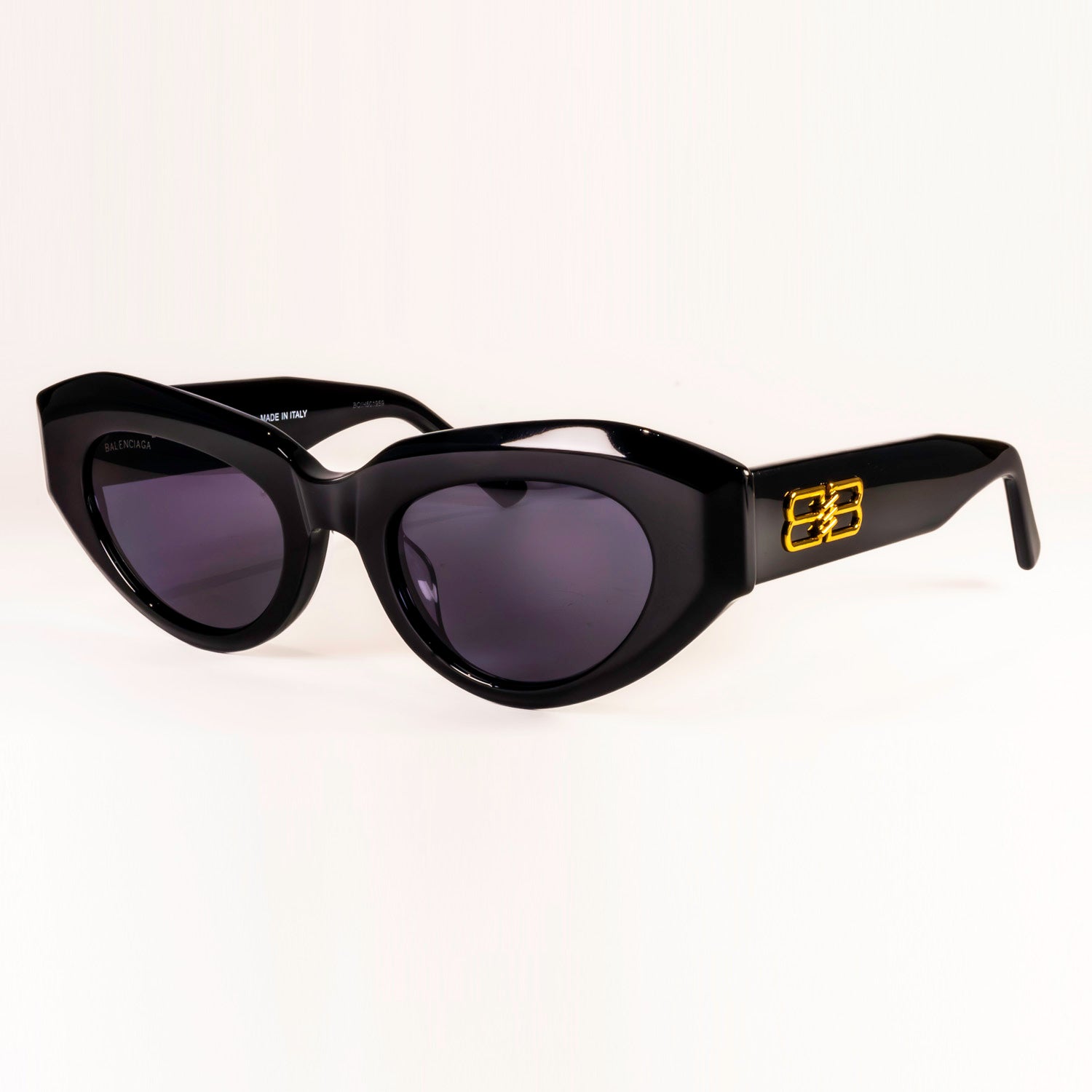 BALENCIAGA SUNGLASSES BB0236S featuring cat-eye shape and grey lenses, set against a stylish background.