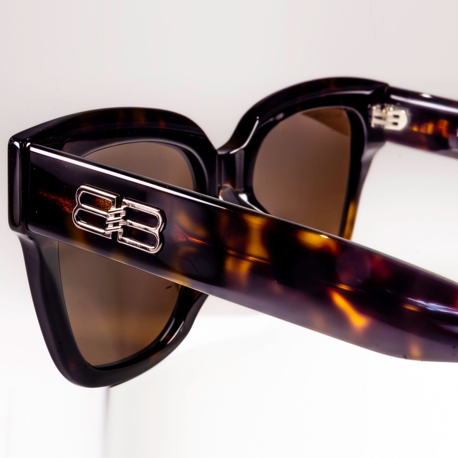 BALENCIAGA SUNGLASSES BB0237SA featuring a sleek black plastic frame and black-grey lenses, designed for style and UV protection.