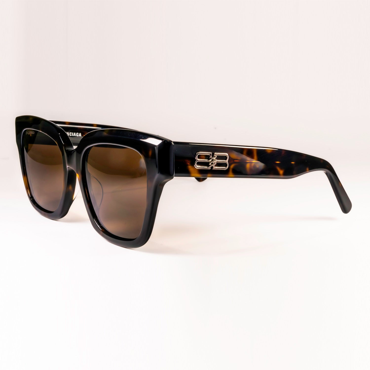 BALENCIAGA SUNGLASSES BB0237SA featuring a sleek black plastic frame and black-grey lenses, designed for style and UV protection.