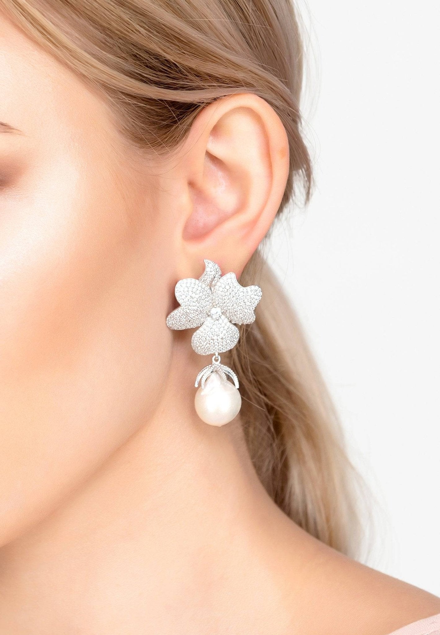 Baroque Pearl White Flower Drop Earrings in silver featuring floral tops and hanging baroque pearls.