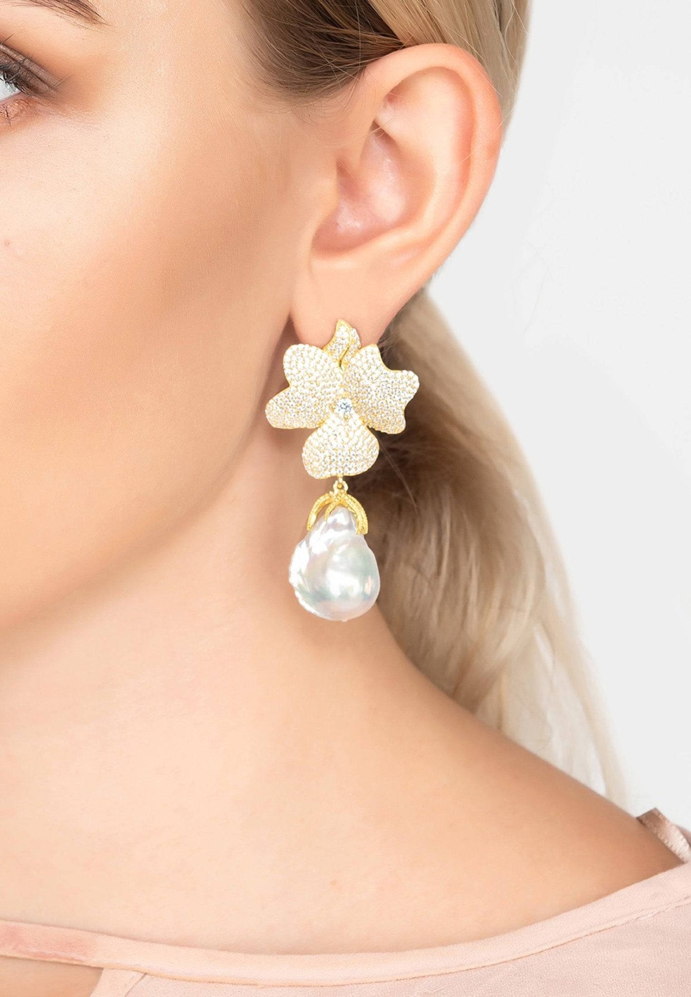 Baroque Pearl White Flower Earrings in yellow gold with floral cubic zirconia tips and dangling baroque pearls.