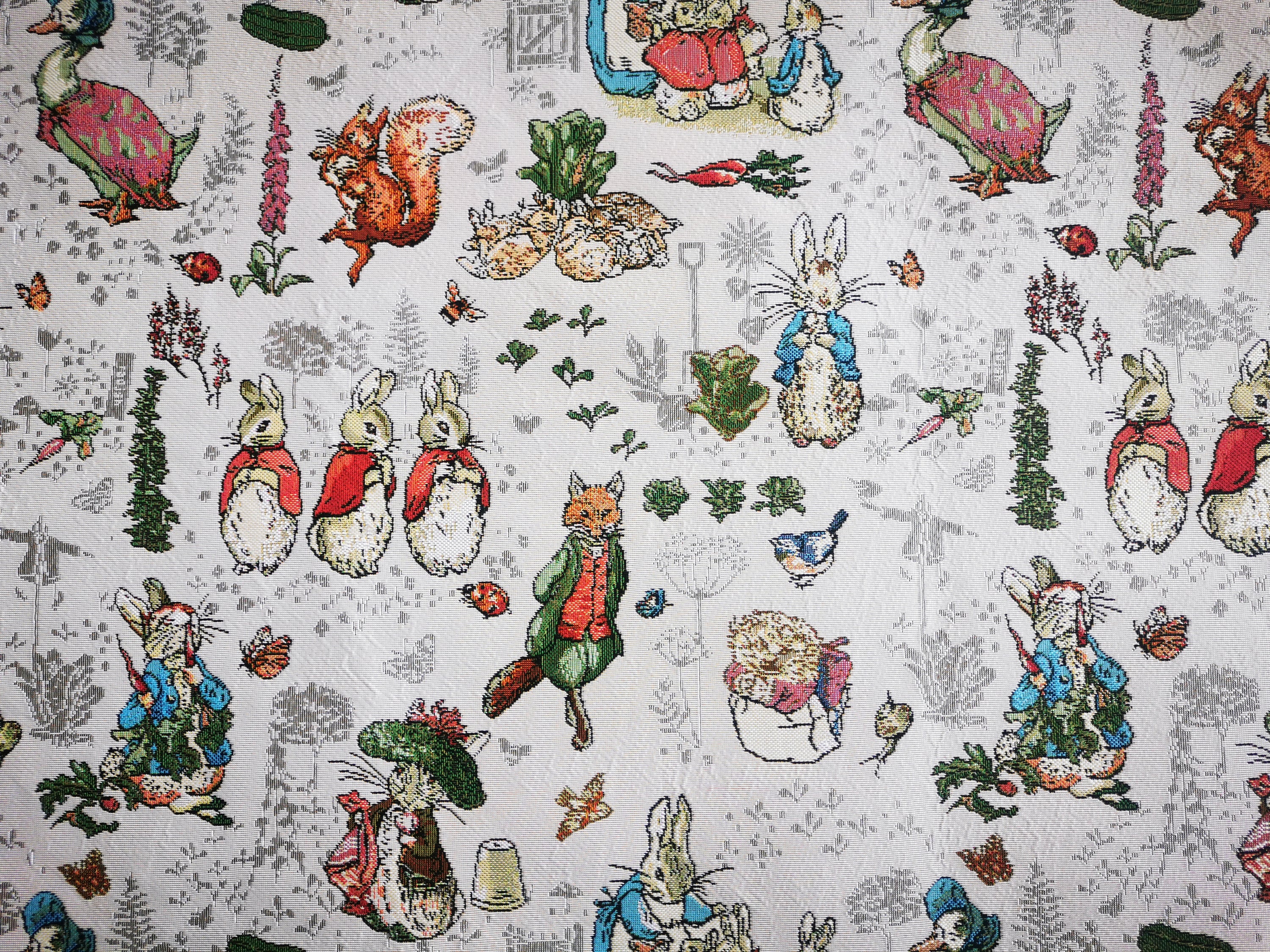 Beatrix Potter Peter Rabbit™ upholstery fabric featuring colorful illustrations of Peter Rabbit in a soft, durable textile.