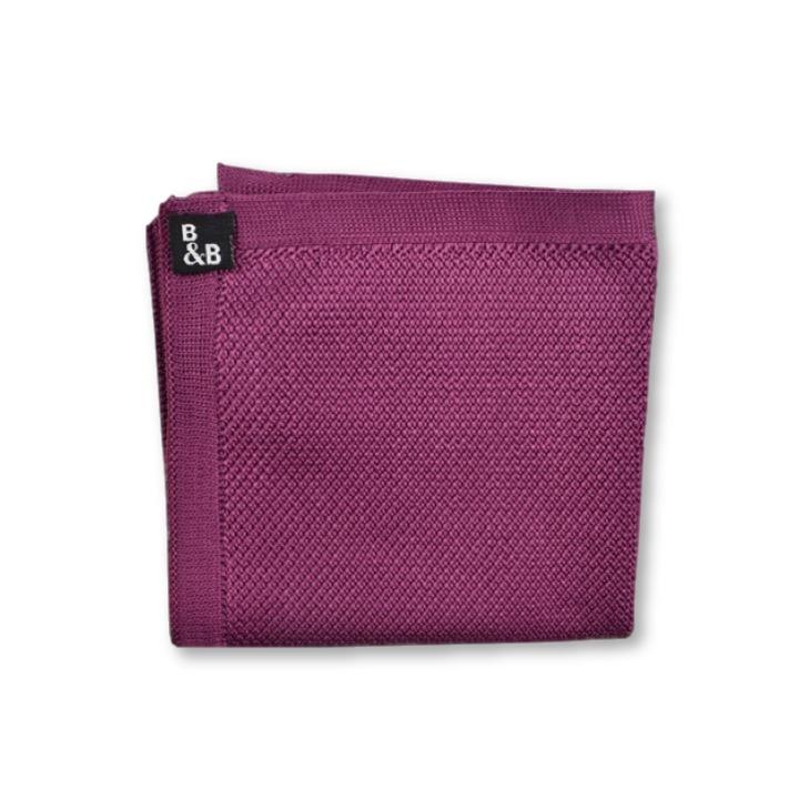 Berry pink knitted pocket square displayed elegantly, showcasing its vibrant color and soft texture.