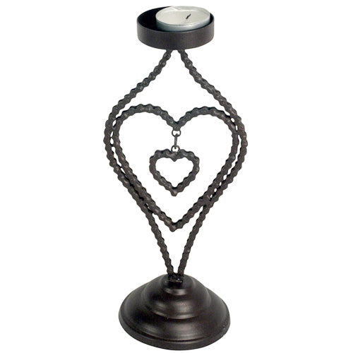 A heart-shaped candle holder made from recycled bicycle chains, featuring a dangling heart inside, showcasing innovative and eco-friendly design.