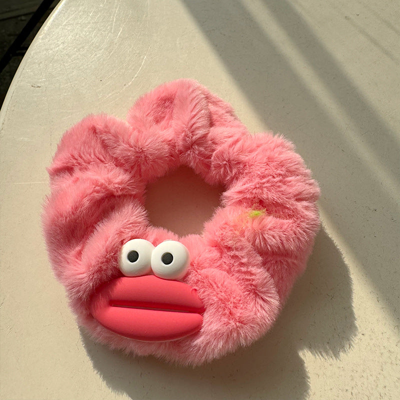 Big Eyed Sausage Mouth Plush Hair Tie featuring a whimsical design with big eyes and a sausage mouth, perfect for adding fun to hairstyles.