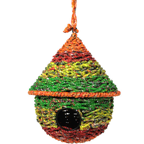 Colorful birdhouse made from recycled candy wrappers, showcasing intricate designs and craftsmanship by artisans in India.