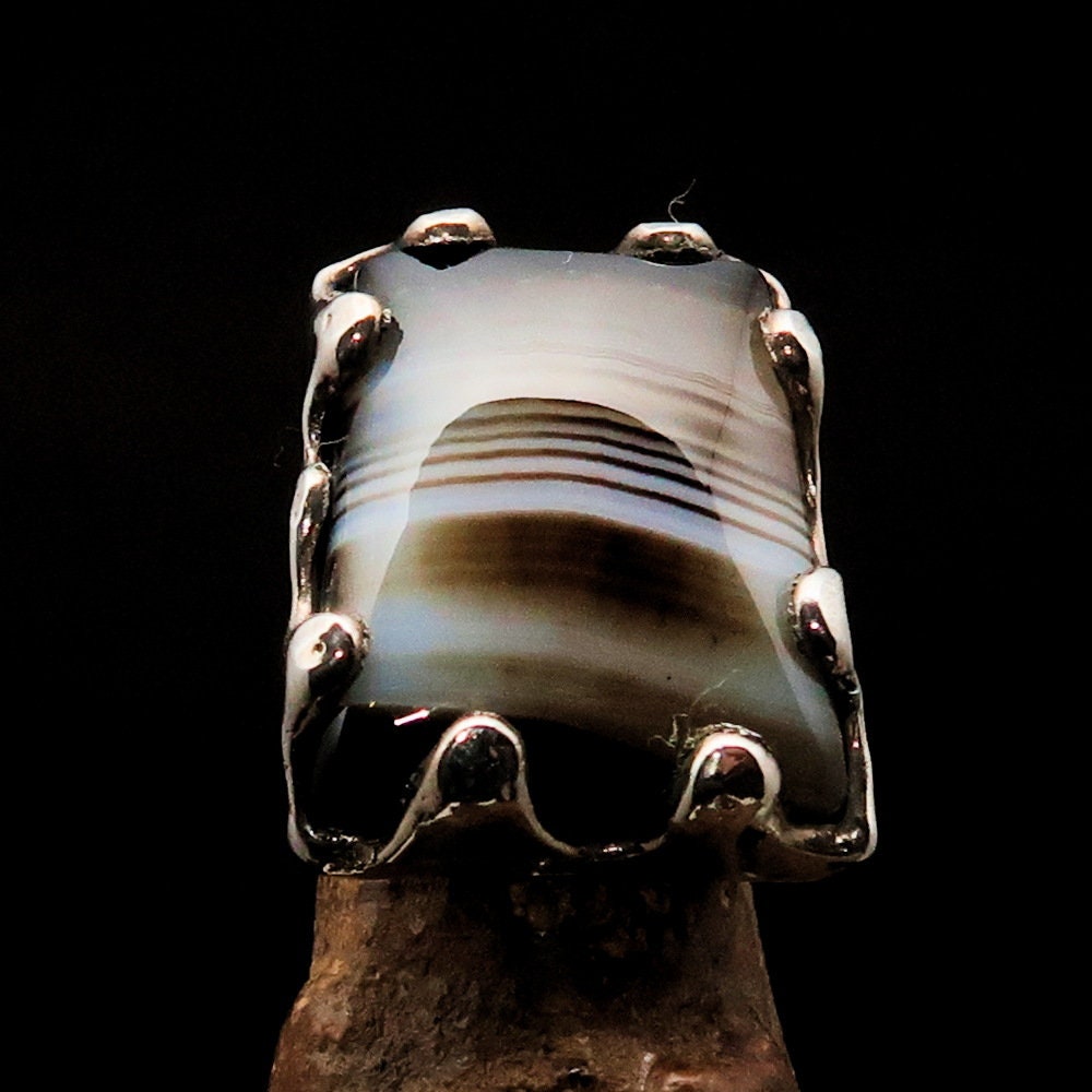 A stunning Black Agate Ring made of sterling silver, featuring a rectangle-shaped black and white Agate Cabochon, showcasing its elegant design.