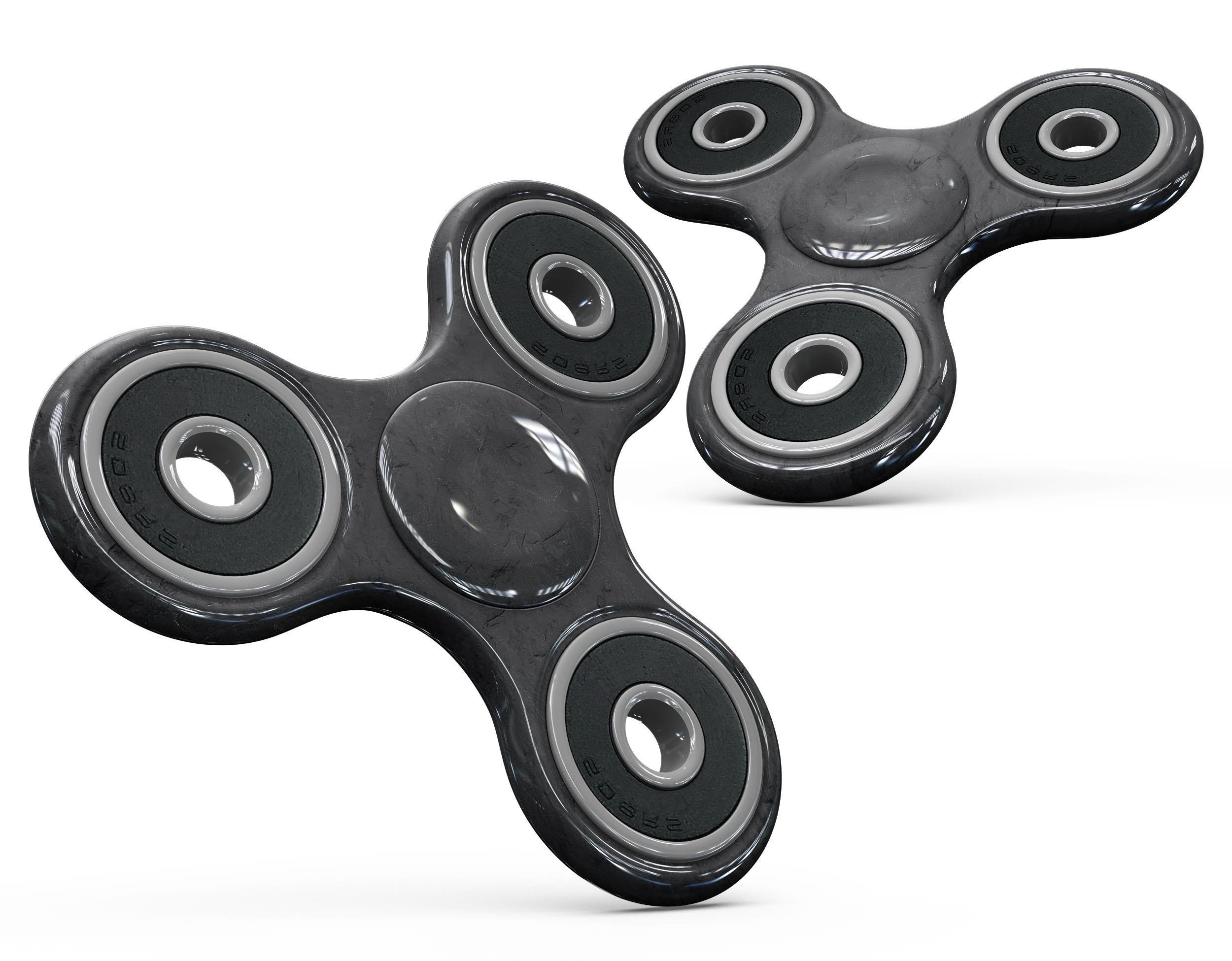 Black and gray textured skin kit for fidget spinner, showcasing a stylish design that offers protection and personalization.