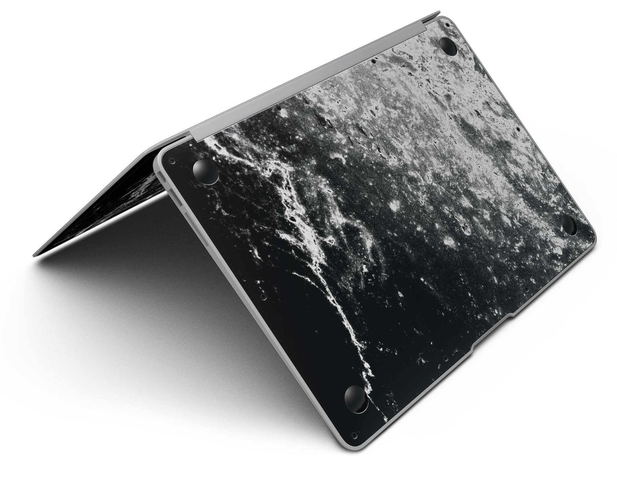 Black and white grungy marble skin applied to a MacBook Air, showcasing its stylish design and sleek finish.