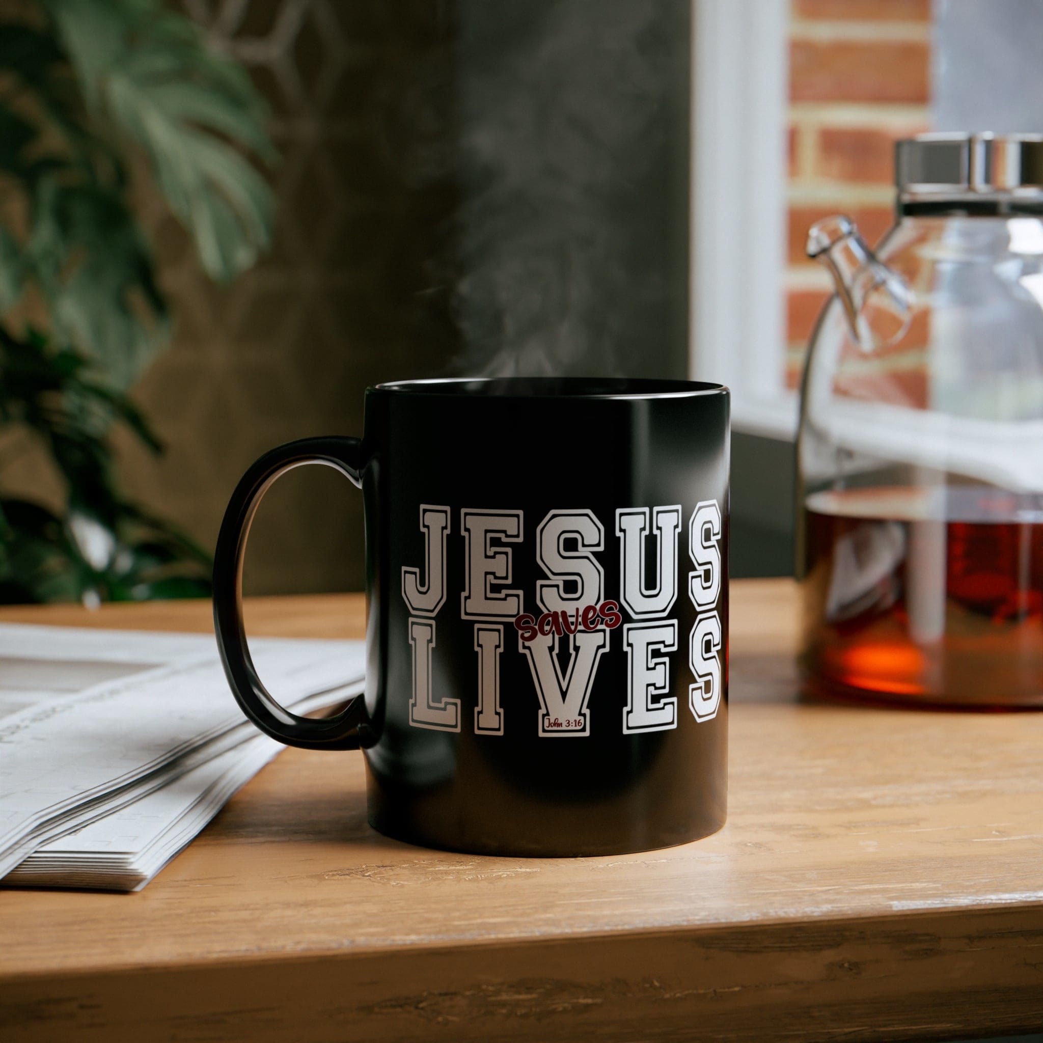 Black ceramic mug with a Jesus Saves Lives illustration in white and red, showcasing a modern design and comfortable handle.