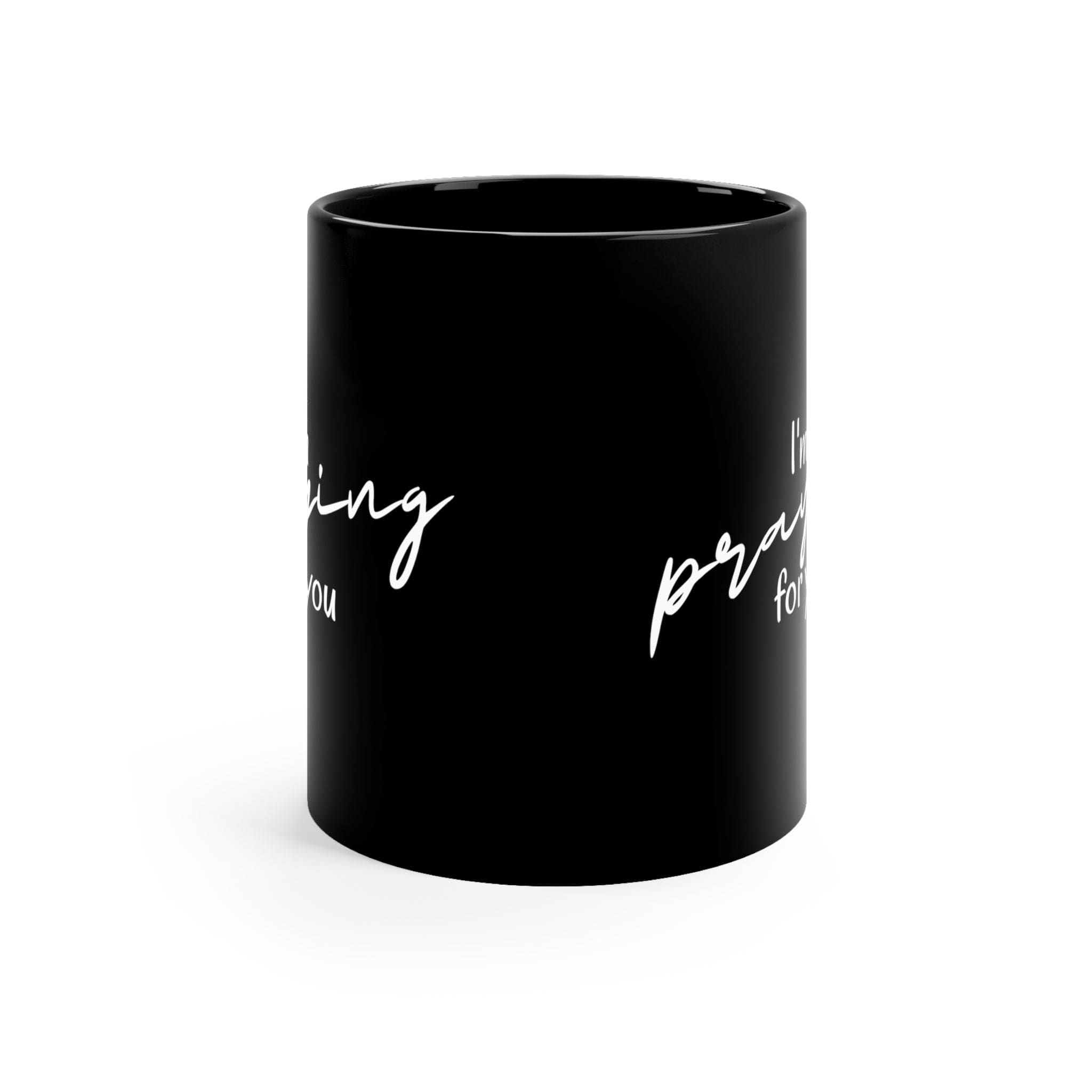 A sleek black ceramic mug with a glossy finish, featuring a C-shaped handle, perfect for coffee or tea.