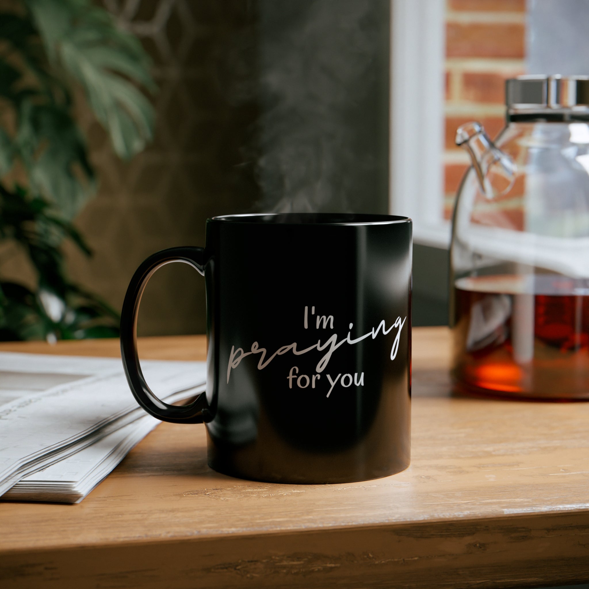 A sleek black ceramic mug with a glossy finish, featuring a C-shaped handle, perfect for coffee or tea.