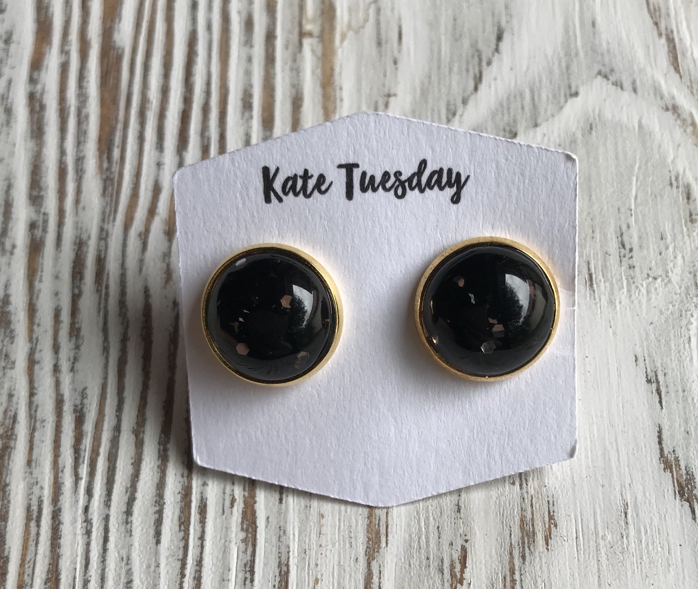 A pair of 12mm black glitter earrings designed for Halloween, showcasing a sparkling finish and lightweight design.