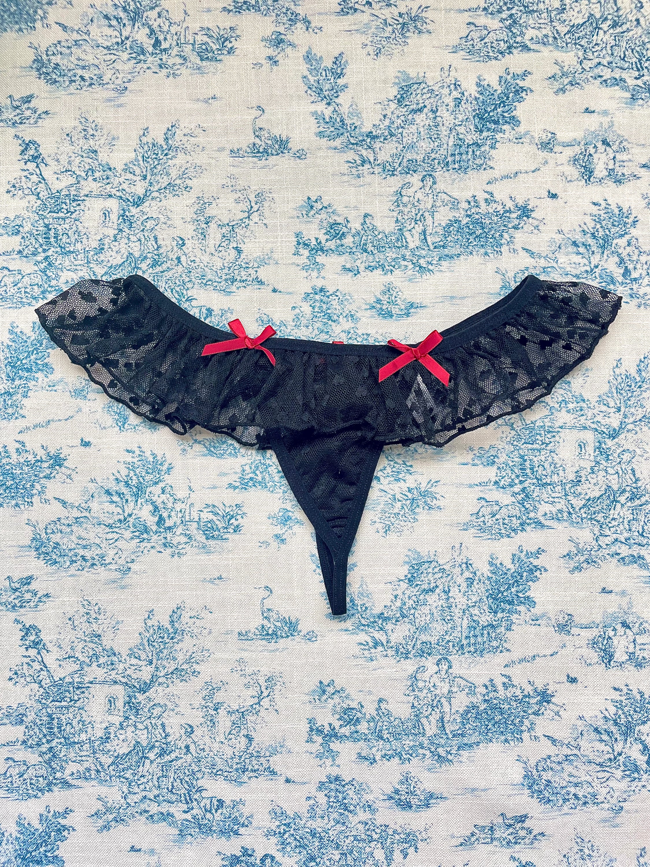 Elegant Black Lace Ruffle Panty with delicate lace ruffles and red bows, showcasing a stylish design.