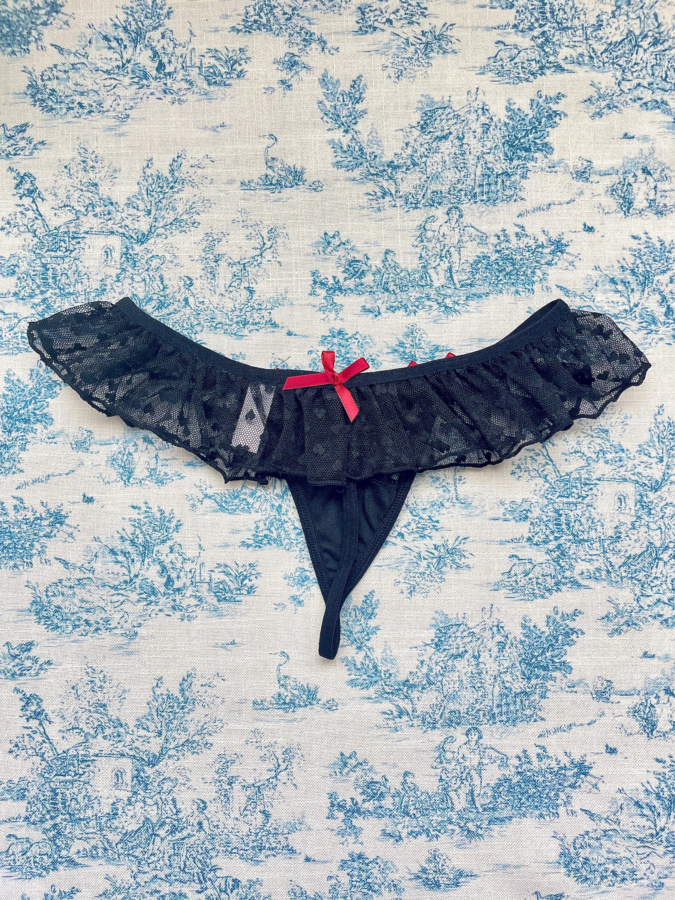 Elegant Black Lace Ruffle Panty with delicate lace ruffles and red bows, showcasing a stylish design.