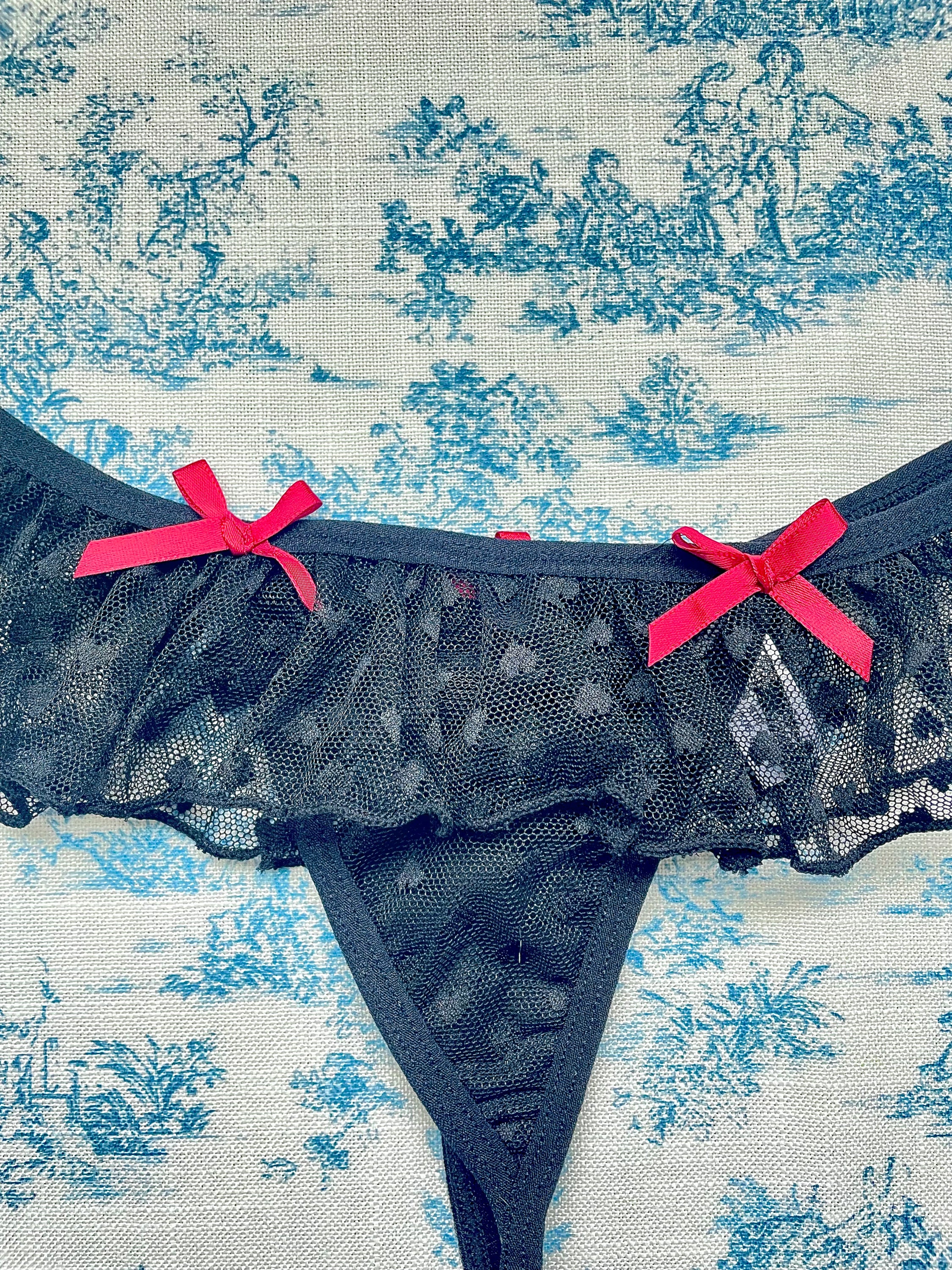 Elegant Black Lace Ruffle Panty with delicate lace ruffles and red bows, showcasing a stylish design.