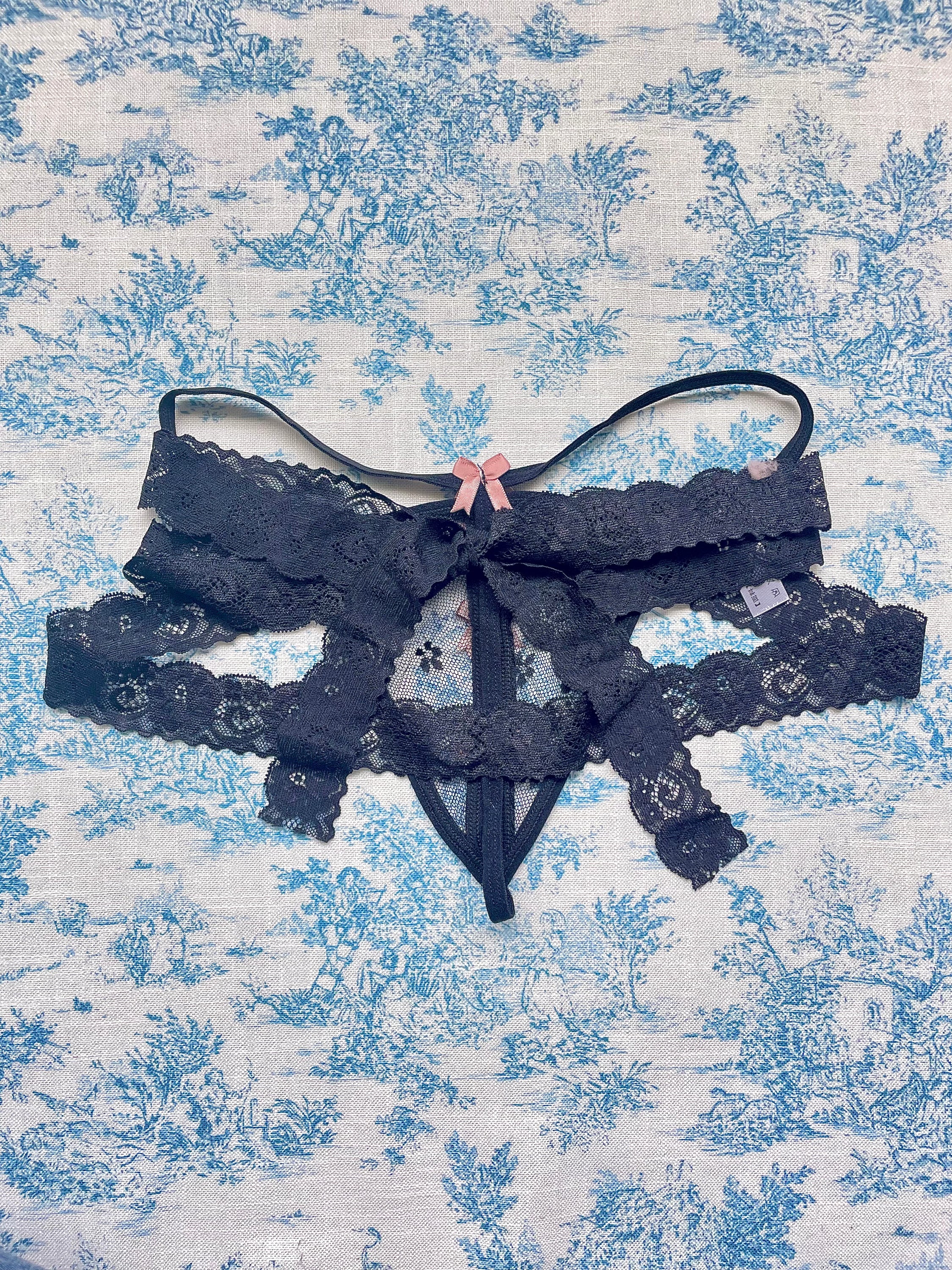 Elegant Black Lace Tie Panty with pink bow details and delicate lace ties, showcasing a sophisticated design.