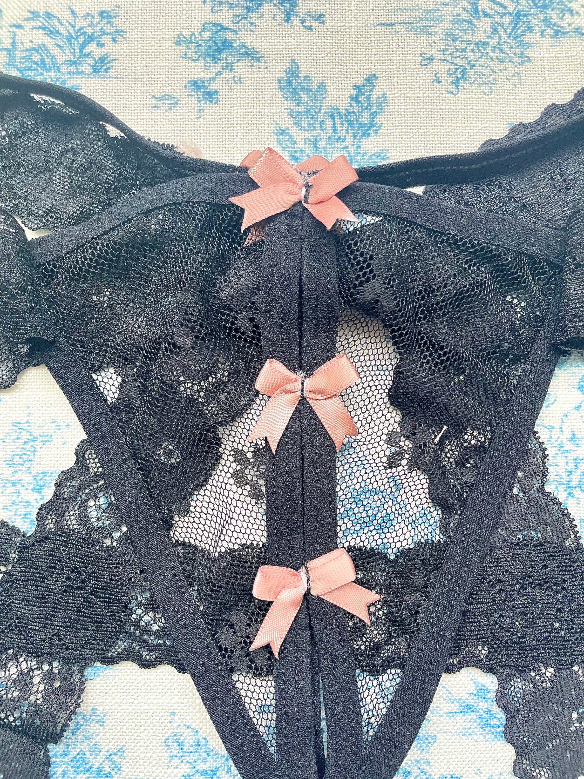 Elegant Black Lace Tie Panty with pink bow details and delicate lace ties, showcasing a sophisticated design.