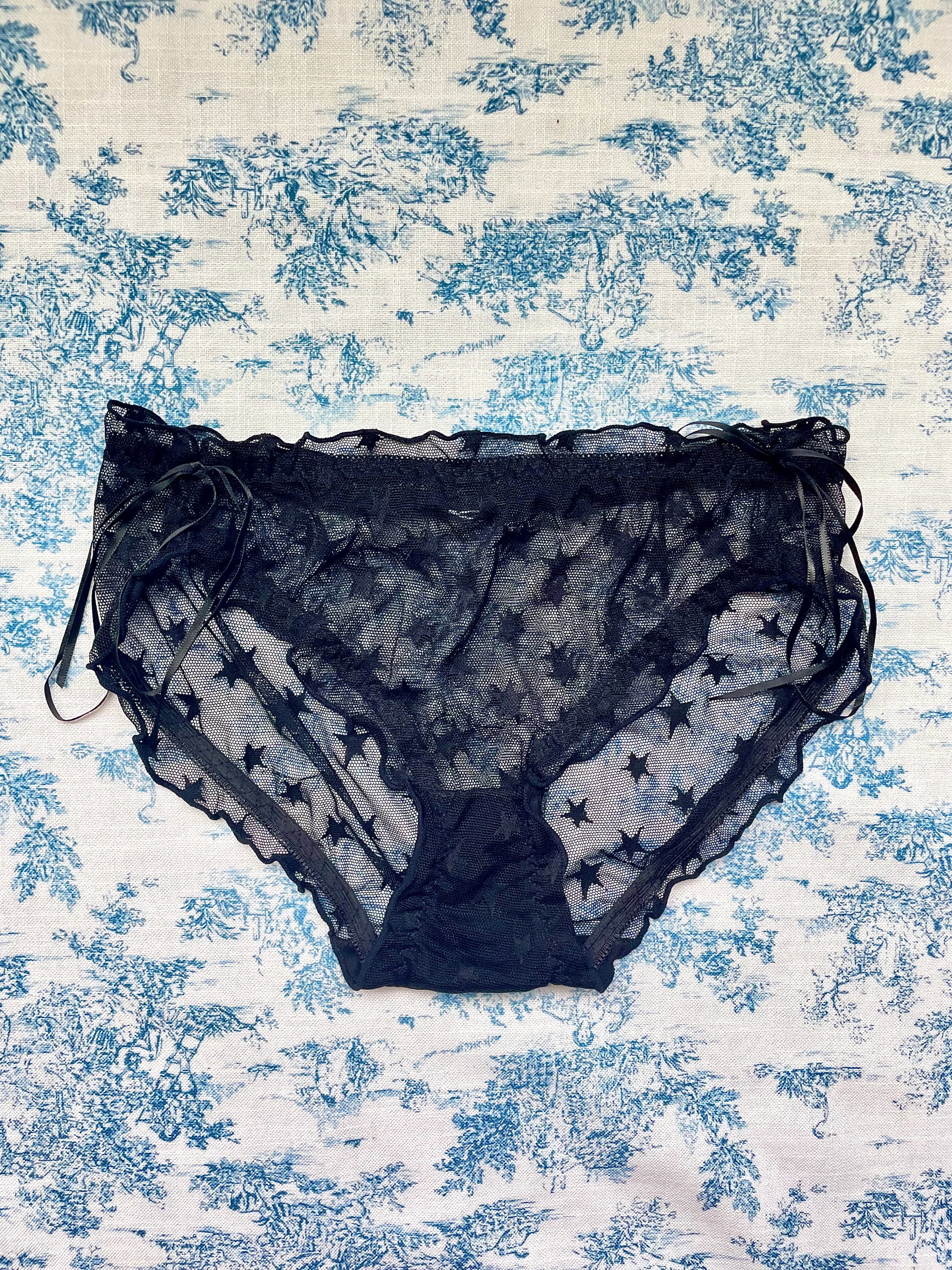 Black Mesh Star Panty featuring a whimsical star pattern and feminine bow accents, designed for comfort and style.