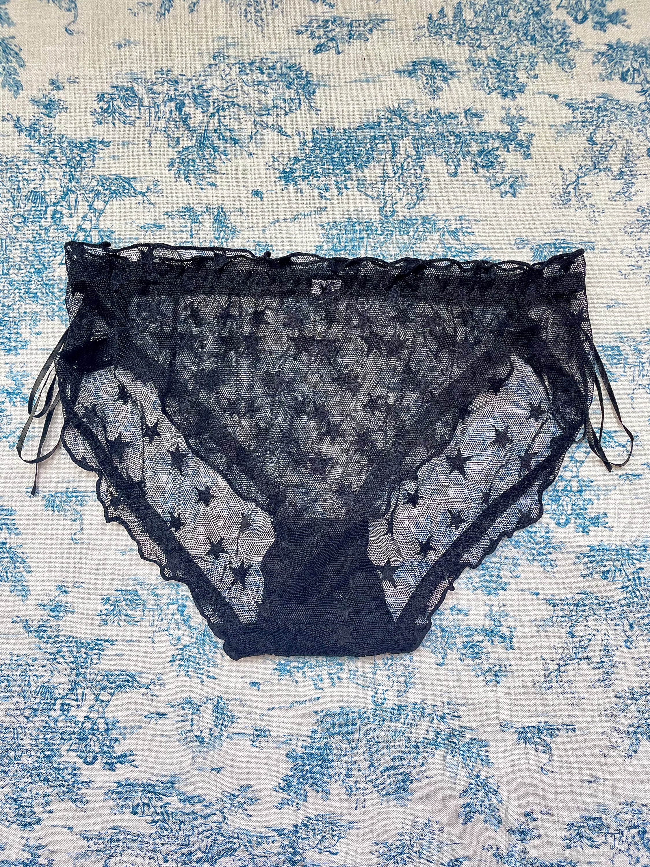 Black Mesh Star Panty featuring a whimsical star pattern and feminine bow accents, designed for comfort and style.