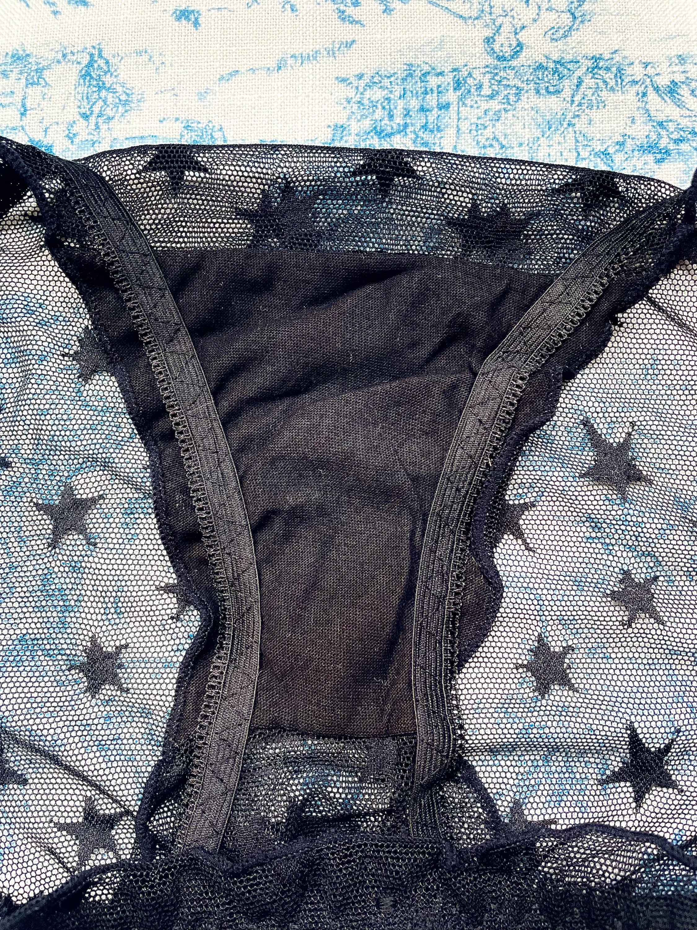 Black Mesh Star Panty featuring a whimsical star pattern and feminine bow accents, designed for comfort and style.