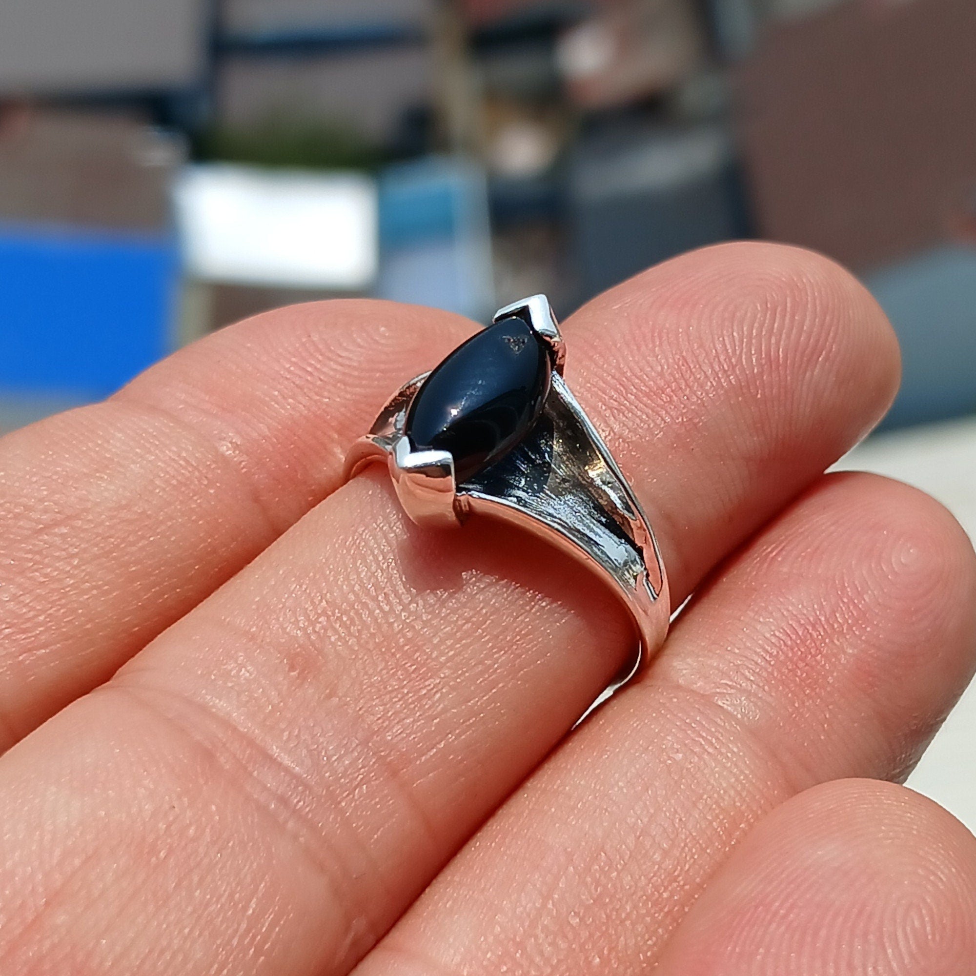 A beautiful Black Onyx Ring made of sterling silver, featuring a marquise shaped black Onyx gemstone with a polished finish.