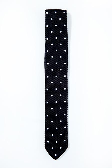 Black silk knitted tie with white polka dots, featuring a pointed end design.