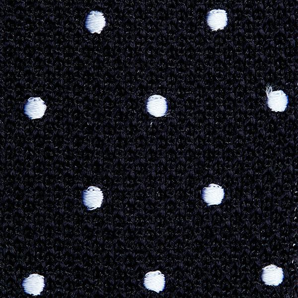 Black silk knitted tie with white polka dots, featuring a pointed end design.