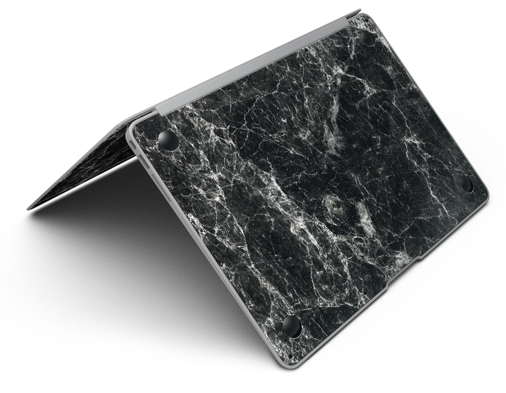 Black Scratched Marble skin applied to a MacBook Air, showcasing its stylish design and sleek finish.