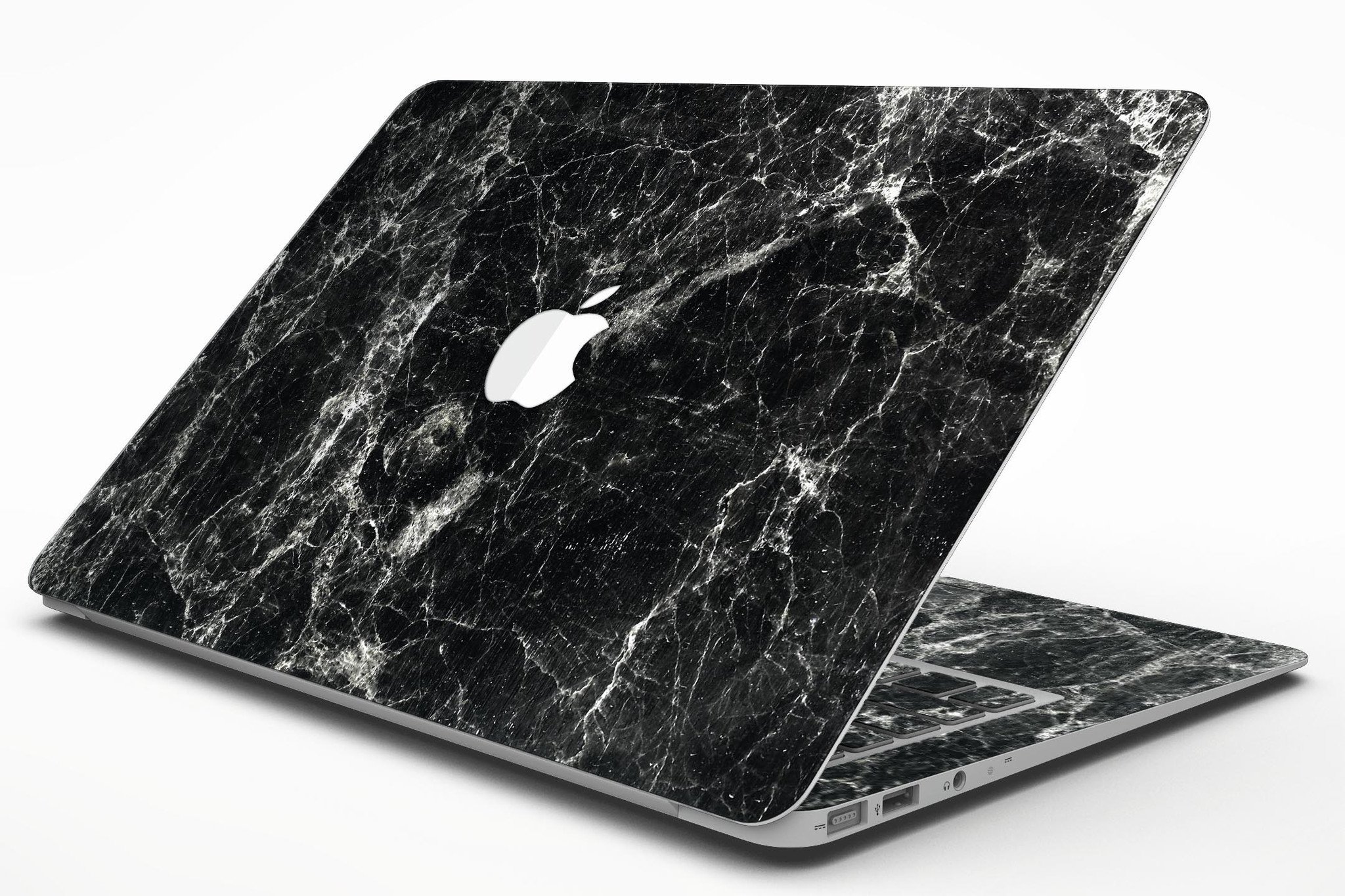 Black Scratched Marble skin applied to a MacBook Air, showcasing its stylish design and sleek finish.