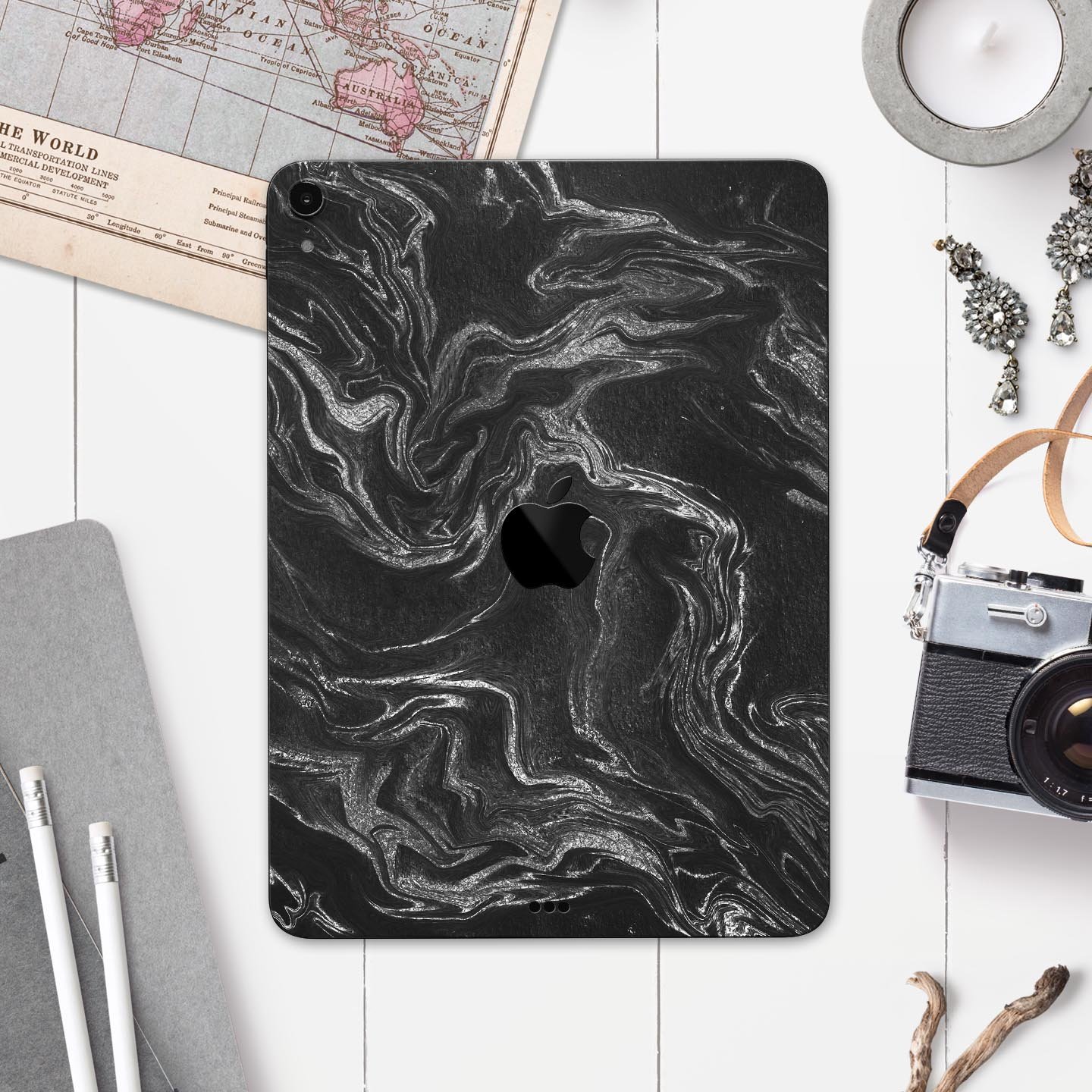 Black and silver marble swirl skin decal for Apple devices, showcasing a stylish design with a premium finish.