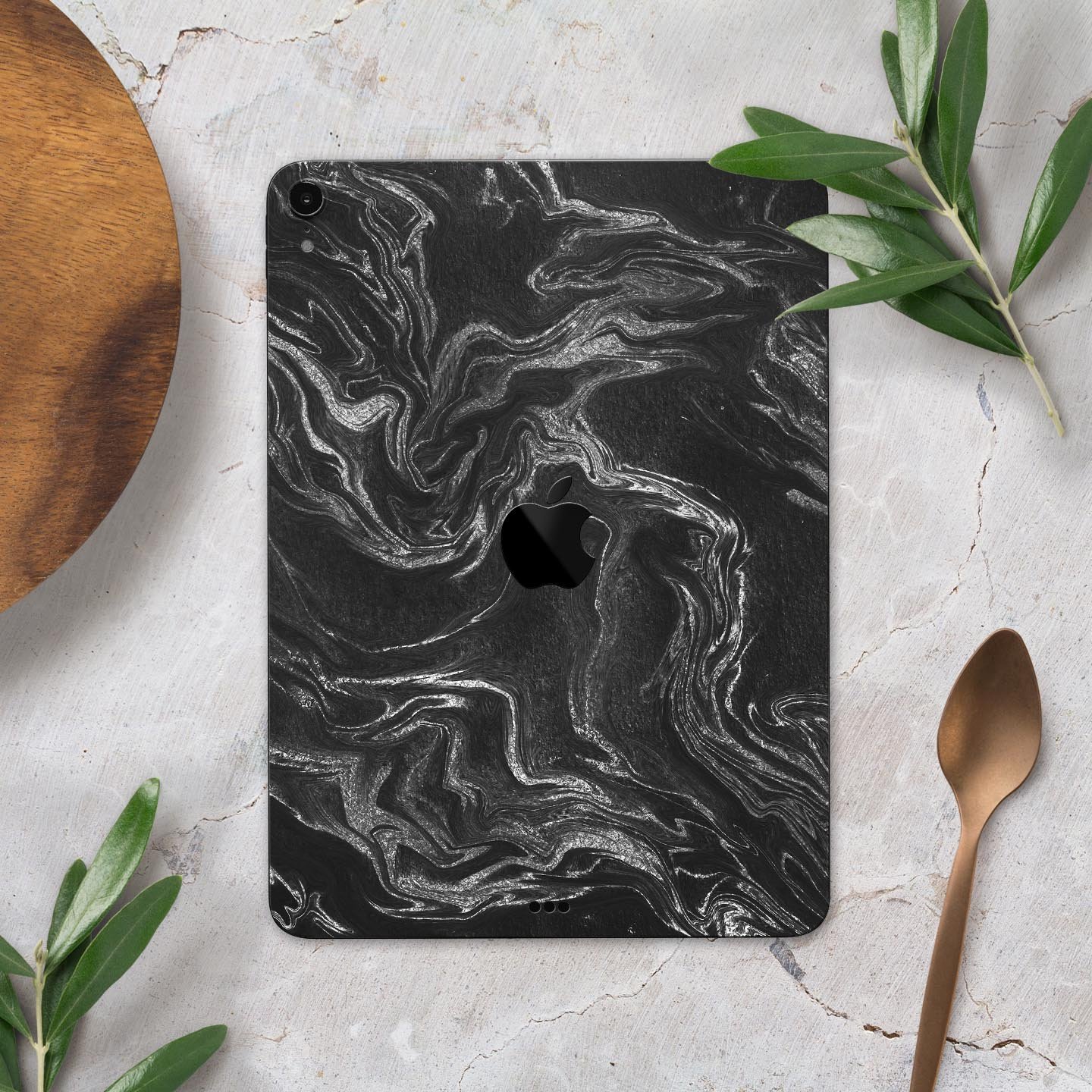 Black and silver marble swirl skin decal for Apple devices, showcasing a stylish design with a premium finish.