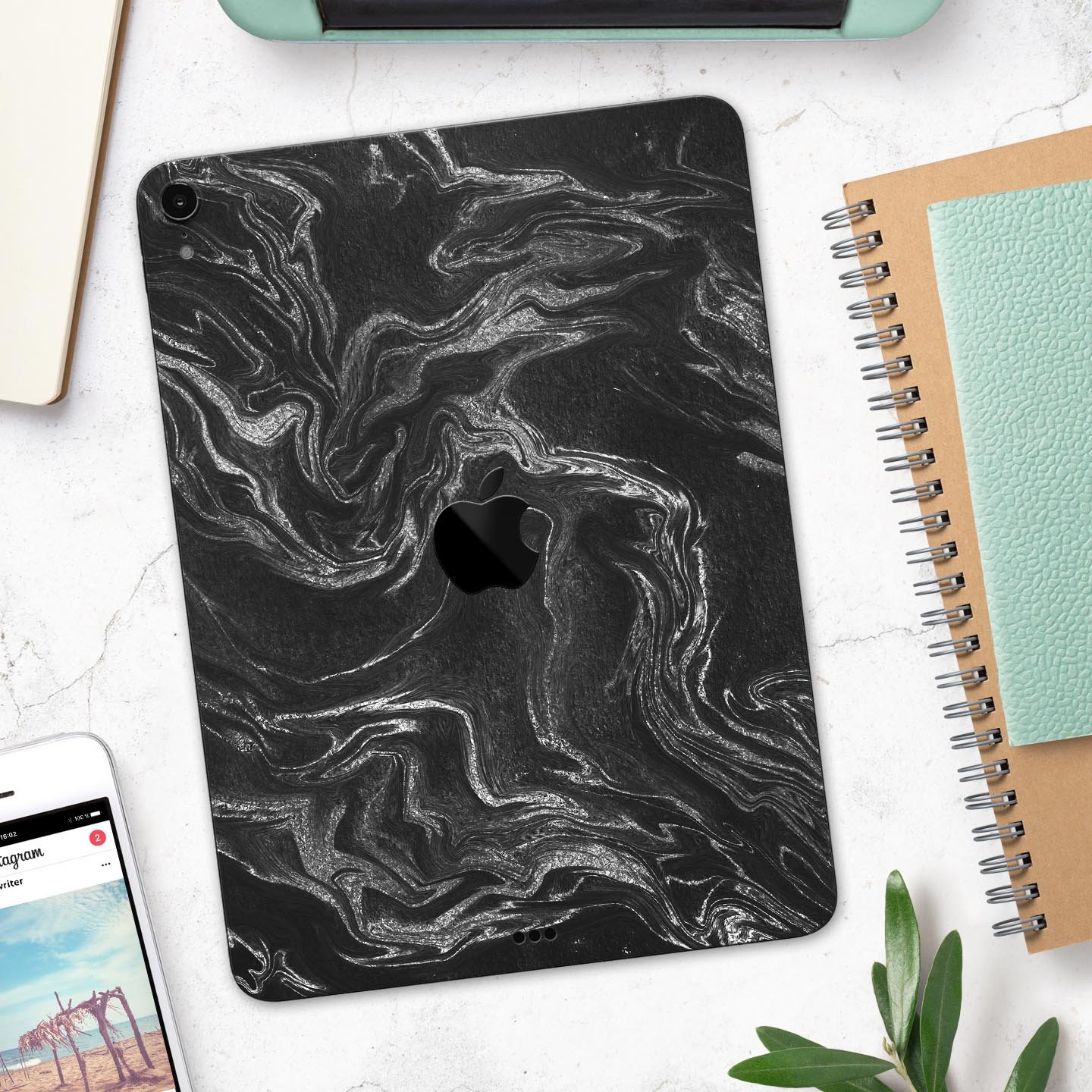 Black and silver marble swirl skin decal for Apple devices, showcasing a stylish design with a premium finish.