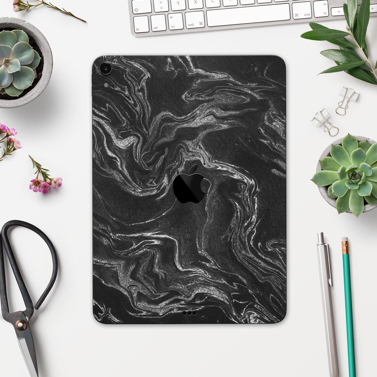 Black and silver marble swirl skin decal for Apple devices, showcasing a stylish design with a premium finish.