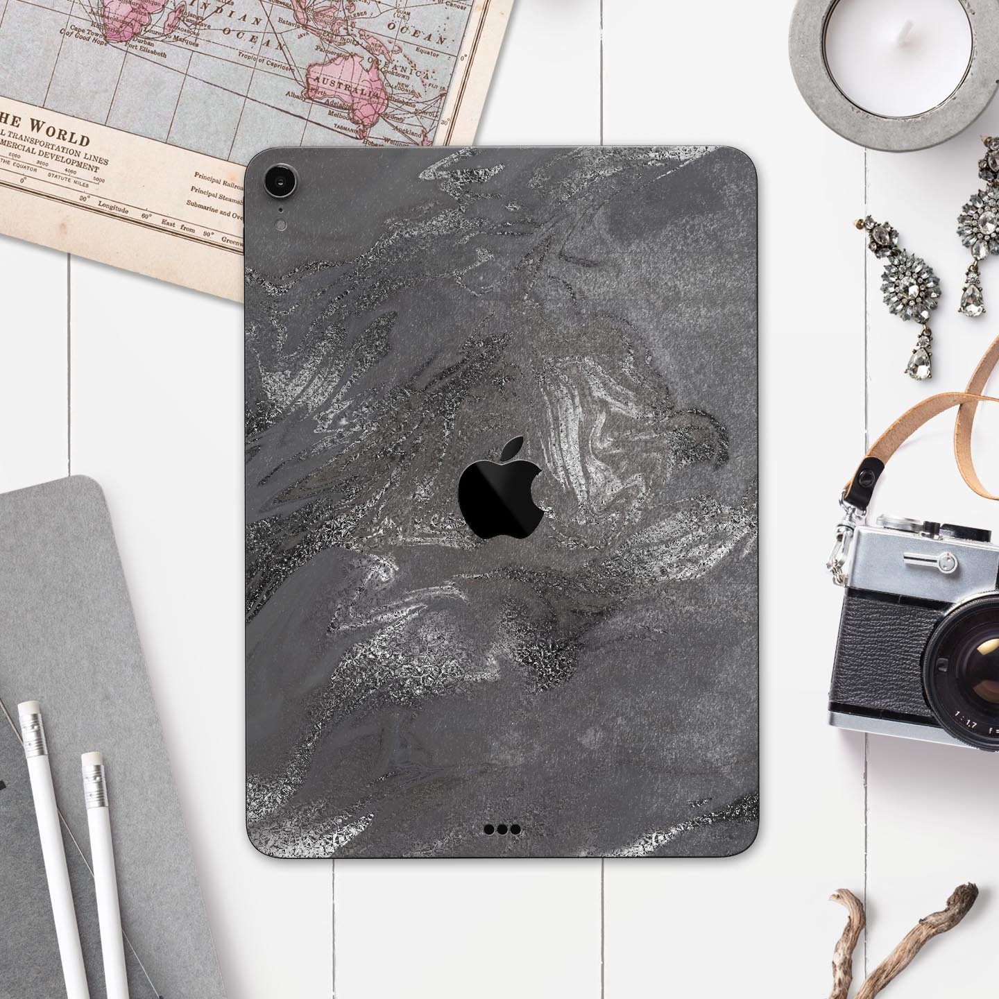 Black and silver marble swirl skin decal for Apple devices, showcasing a stylish design with a premium finish.