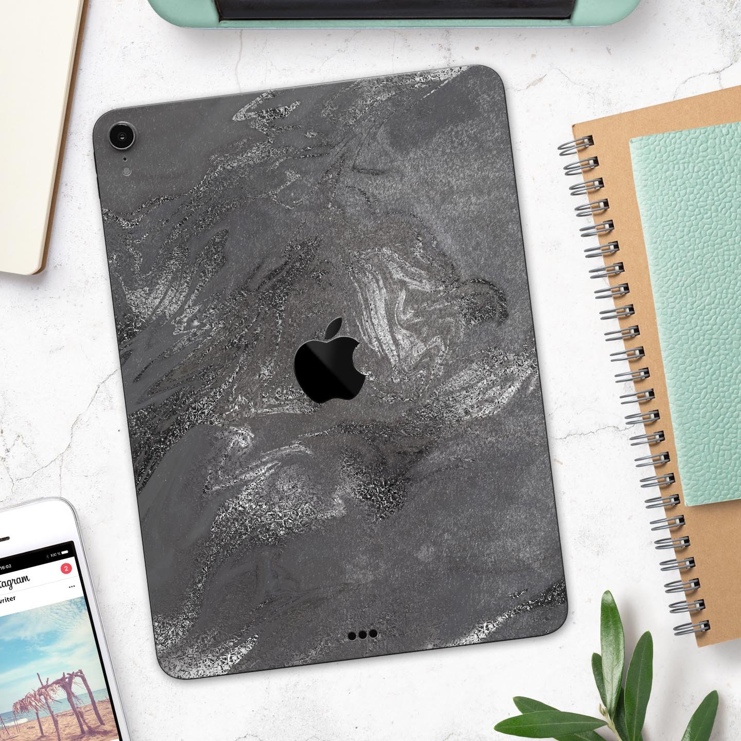 Black and silver marble swirl skin decal for Apple devices, showcasing a stylish design with a premium finish.