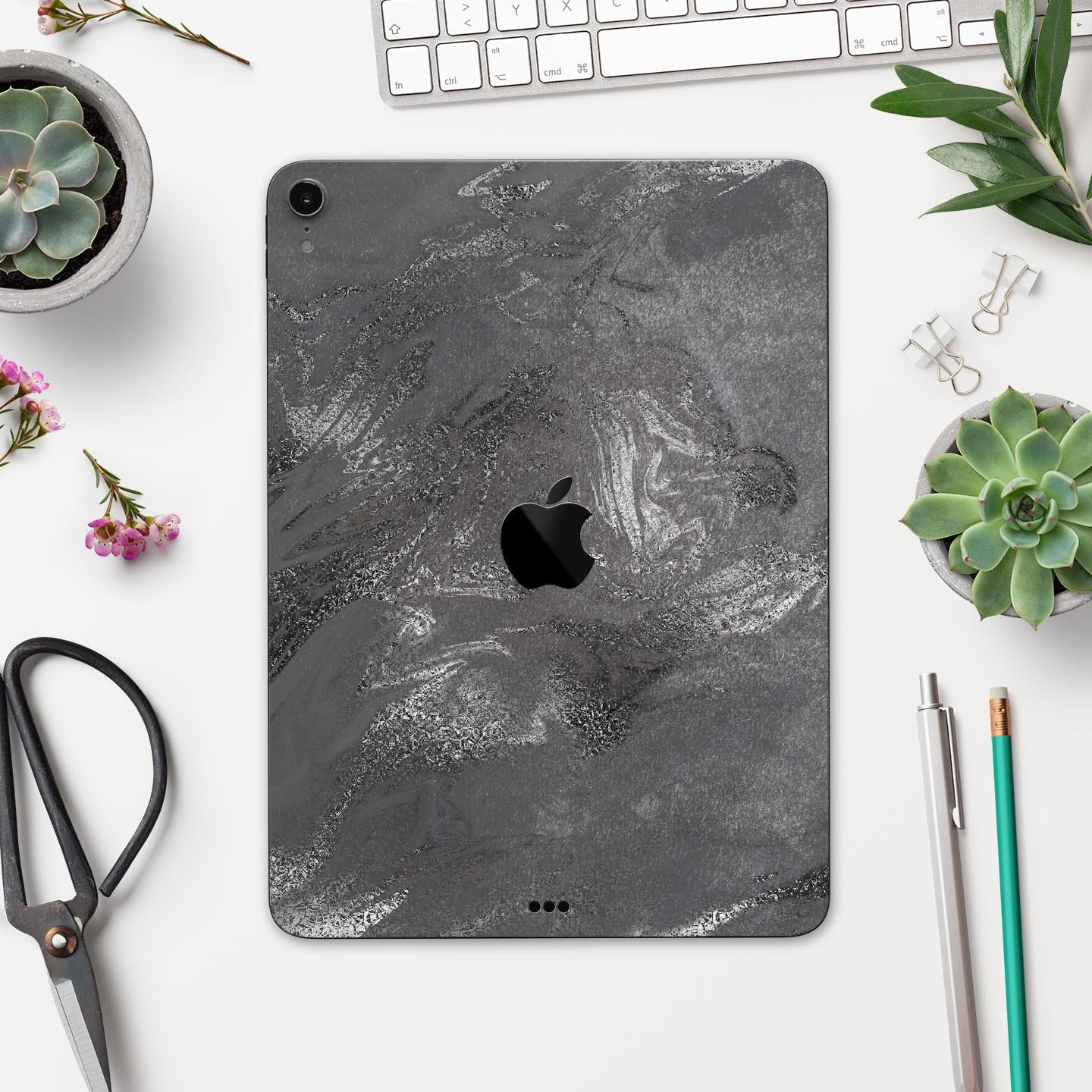 Black and silver marble swirl skin decal for Apple devices, showcasing a stylish design with a premium finish.