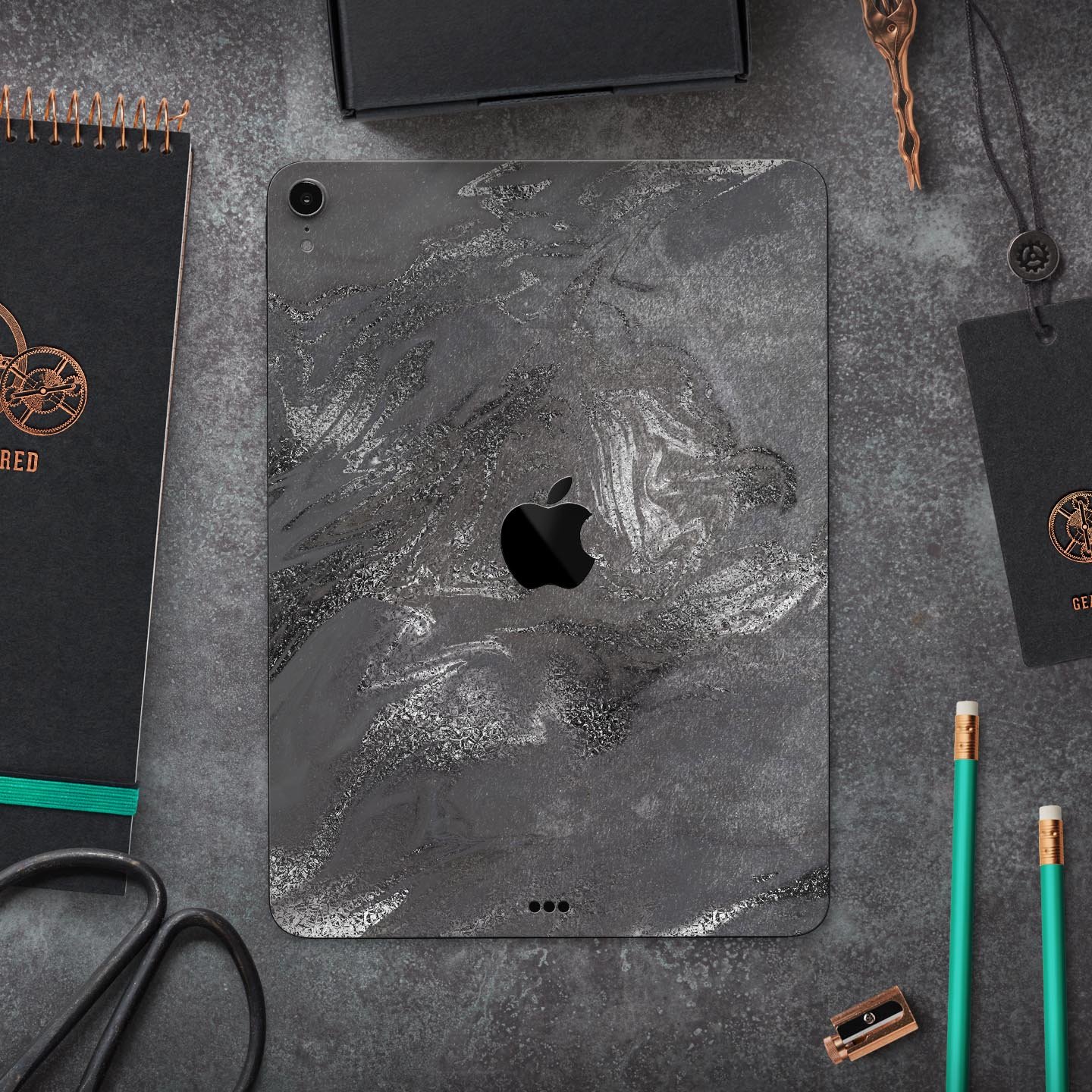 Black and silver marble swirl skin decal for Apple devices, showcasing a stylish design with a premium finish.