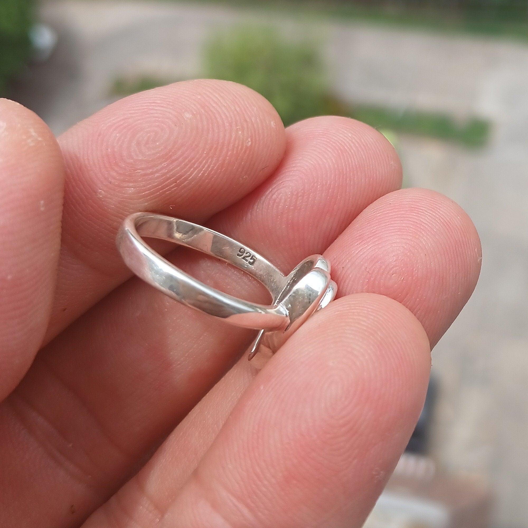 Elegant Black Star Sapphire Ring in sterling silver with an oval-shaped black stone and polished finish.