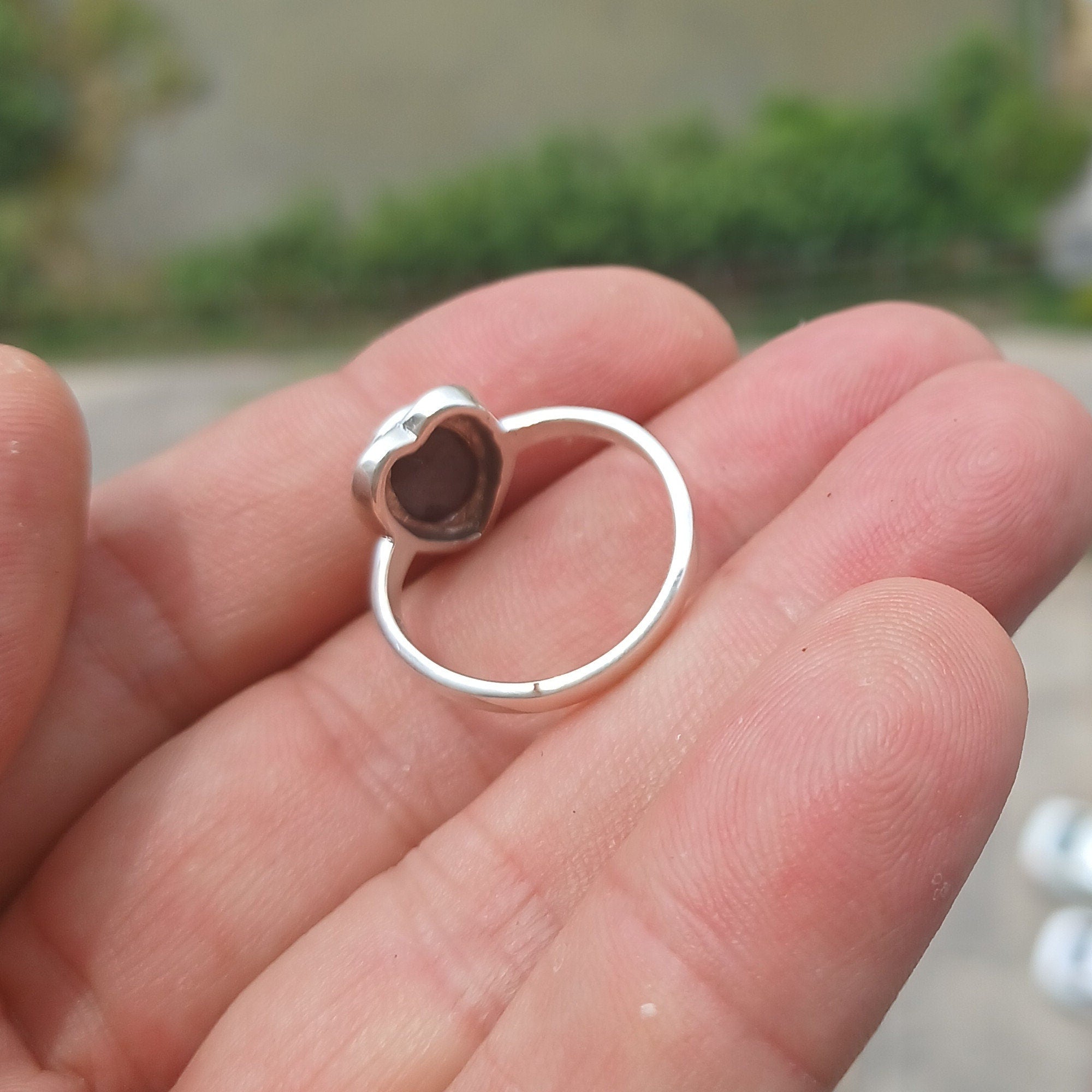 Elegant Black Star Sapphire Ring in sterling silver with an oval-shaped black stone and polished finish.