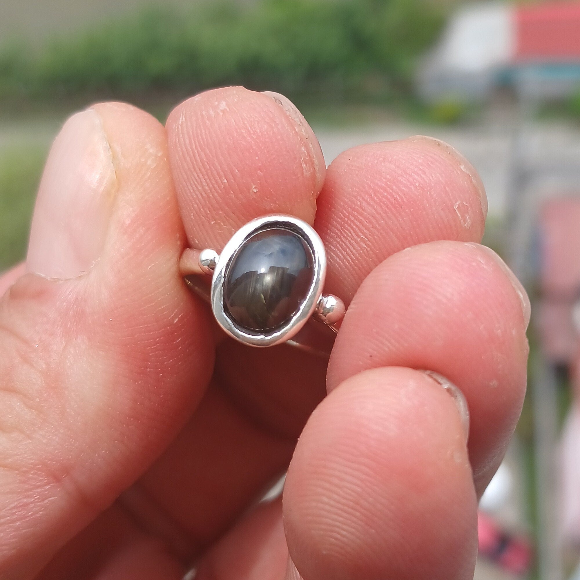 Elegant Black Star Sapphire Ring in sterling silver with a polished finish, featuring an oval-shaped black sapphire stone.