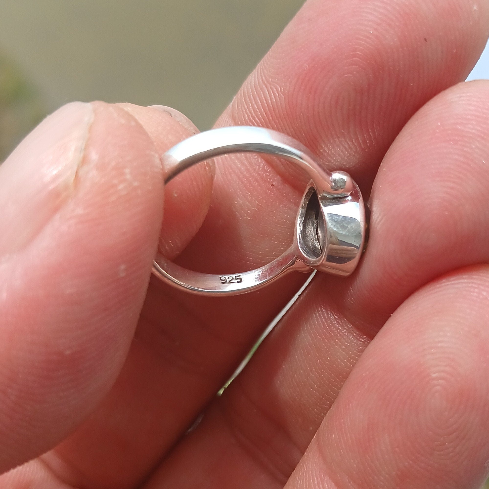 Elegant Black Star Sapphire Ring in sterling silver with a polished finish, featuring an oval-shaped black sapphire stone.