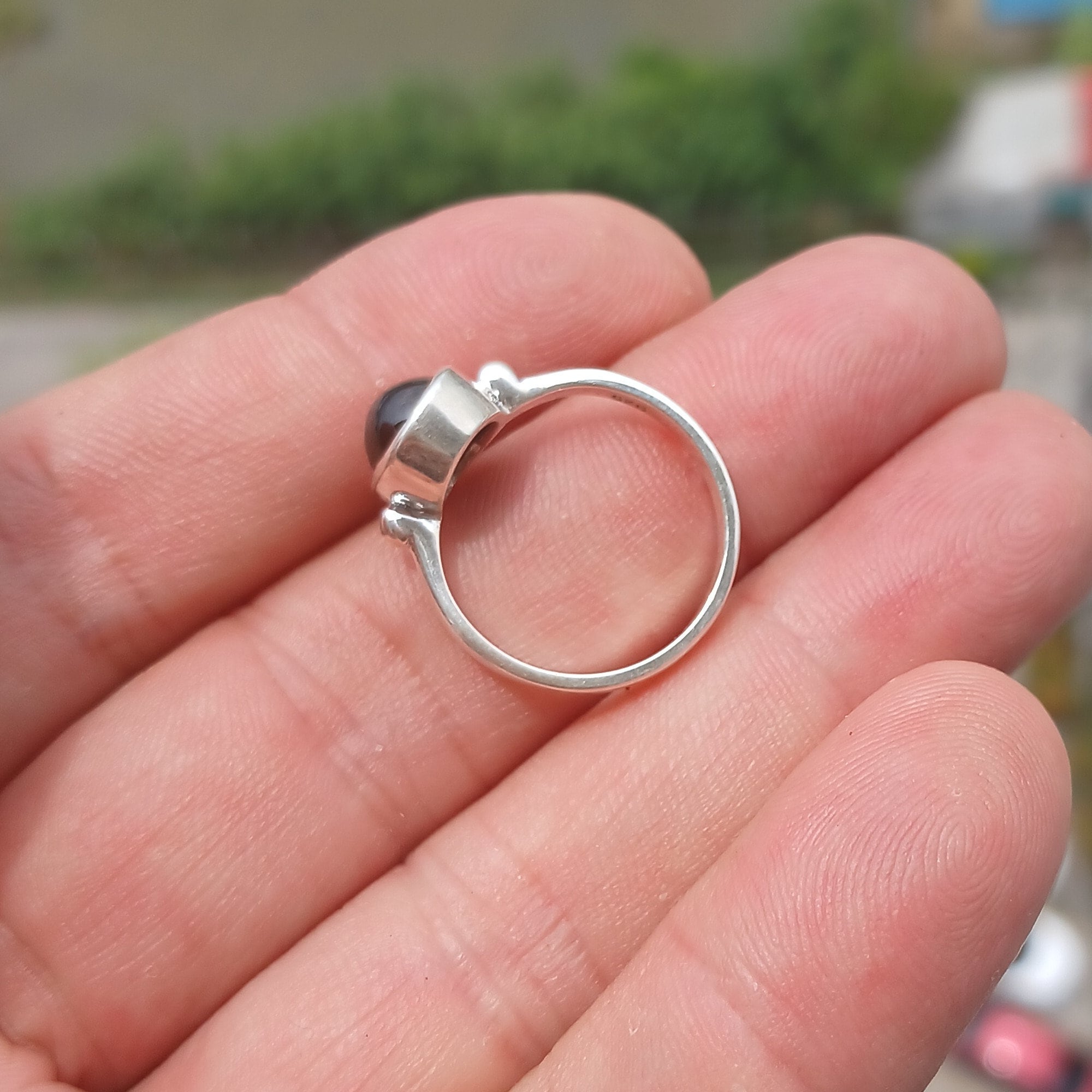 Elegant Black Star Sapphire Ring in sterling silver with a polished finish, featuring an oval-shaped black sapphire stone.