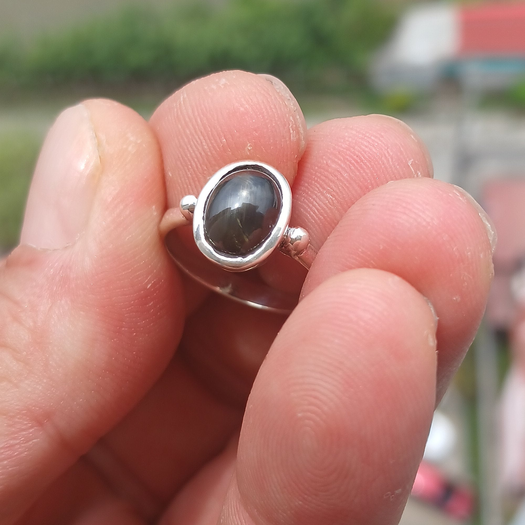 Elegant Black Star Sapphire Ring in sterling silver with a polished finish, featuring an oval-shaped black sapphire stone.