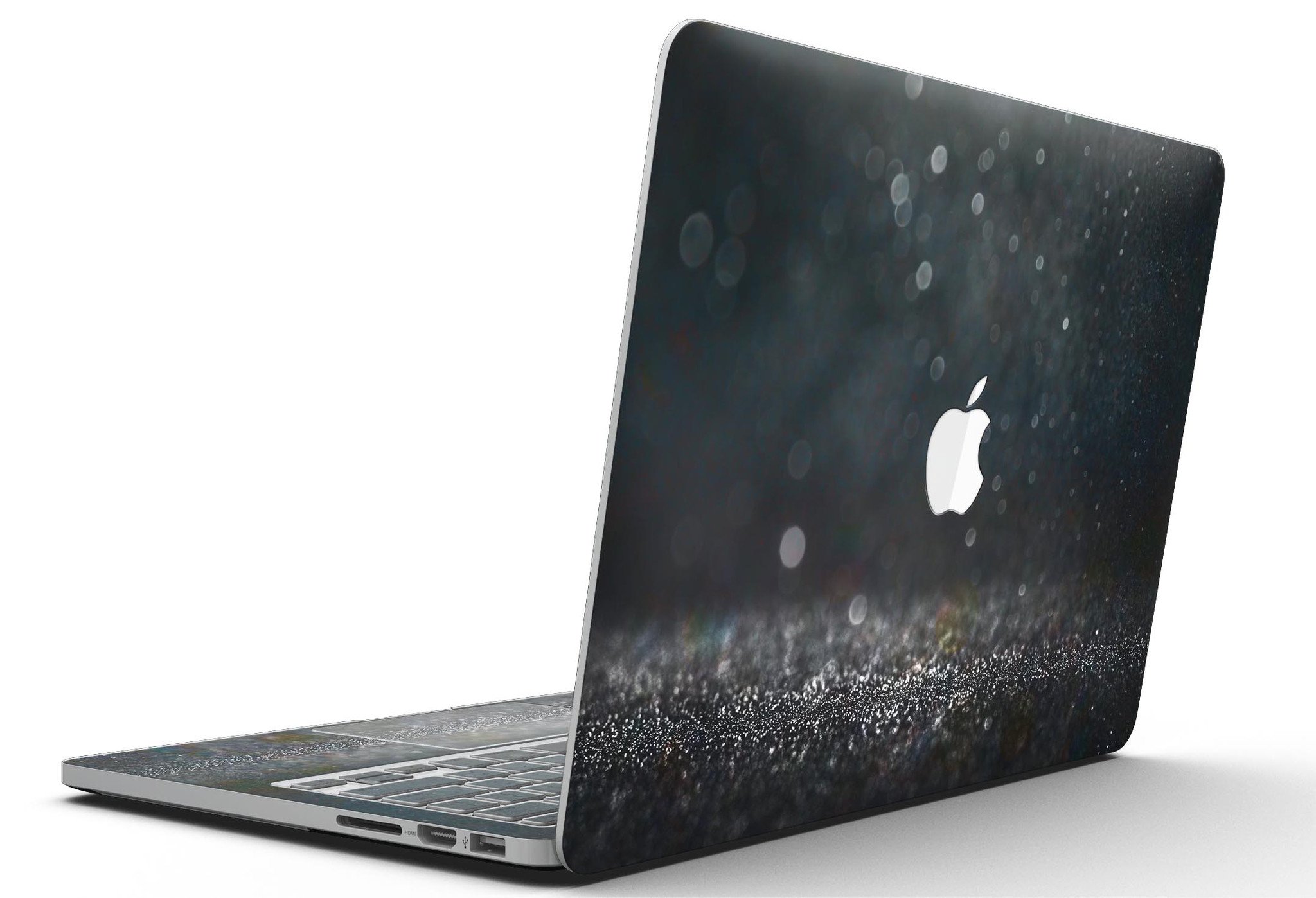 Black Unfocused Glowing Shimmer skin applied to a MacBook Pro with Retina Display, showcasing its sleek design and vibrant colors.