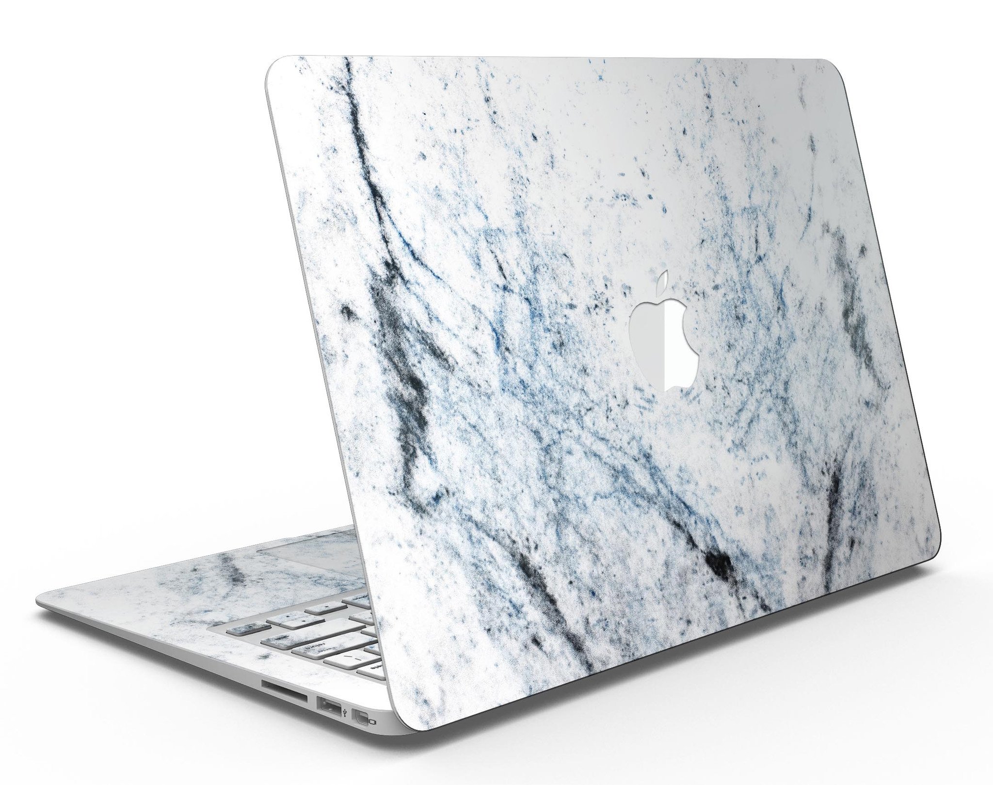 Blue and black grunge skin for MacBook Air on a white marble surface, showcasing stylish design and premium vinyl material.