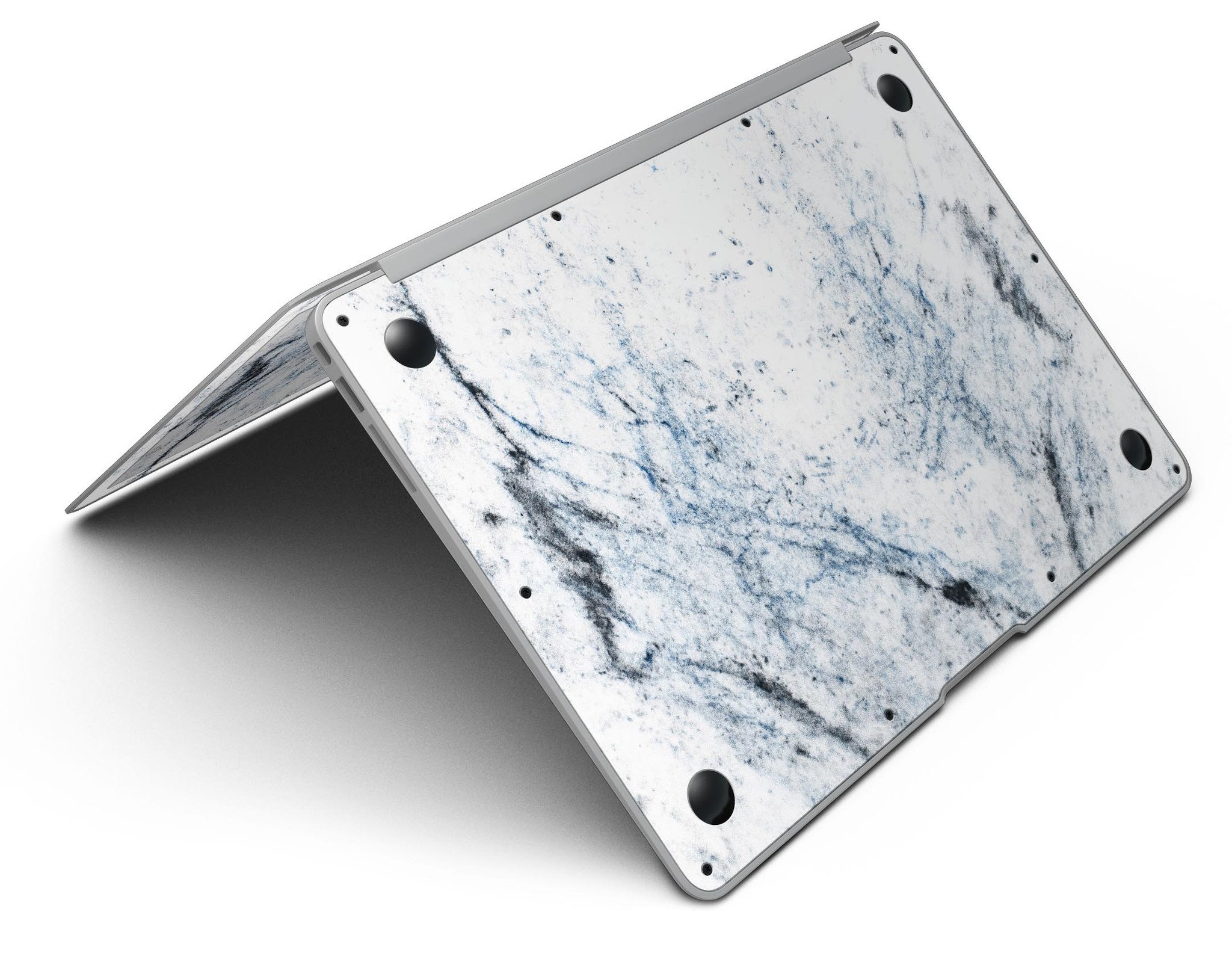 Blue and black grunge skin for MacBook Air on a white marble surface, showcasing stylish design and premium vinyl material.